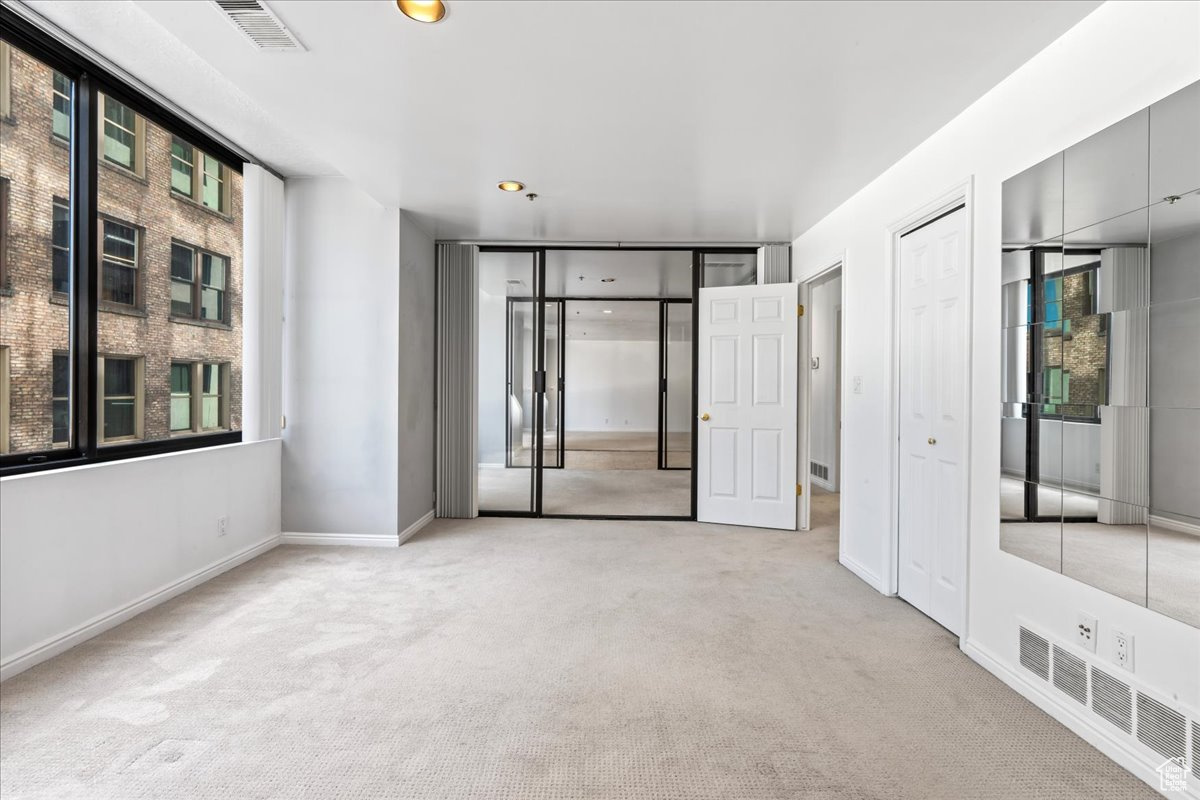 Empty room featuring light colored carpet