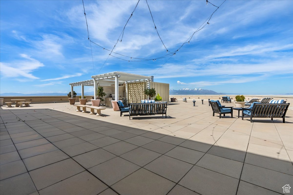 View of patio featuring a pergola, a mountain view, and an outdoor hangout area