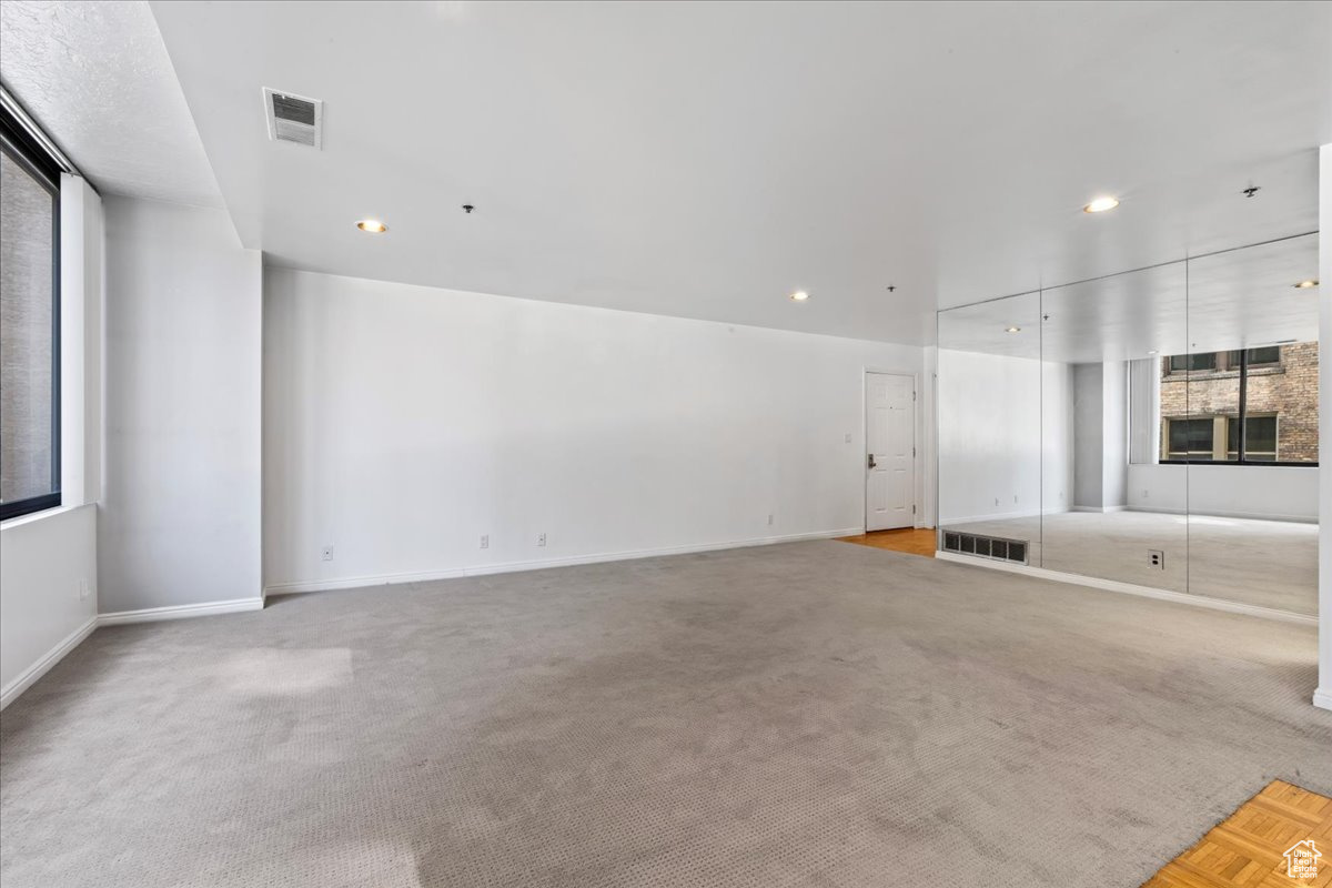 Unfurnished living room with light carpet