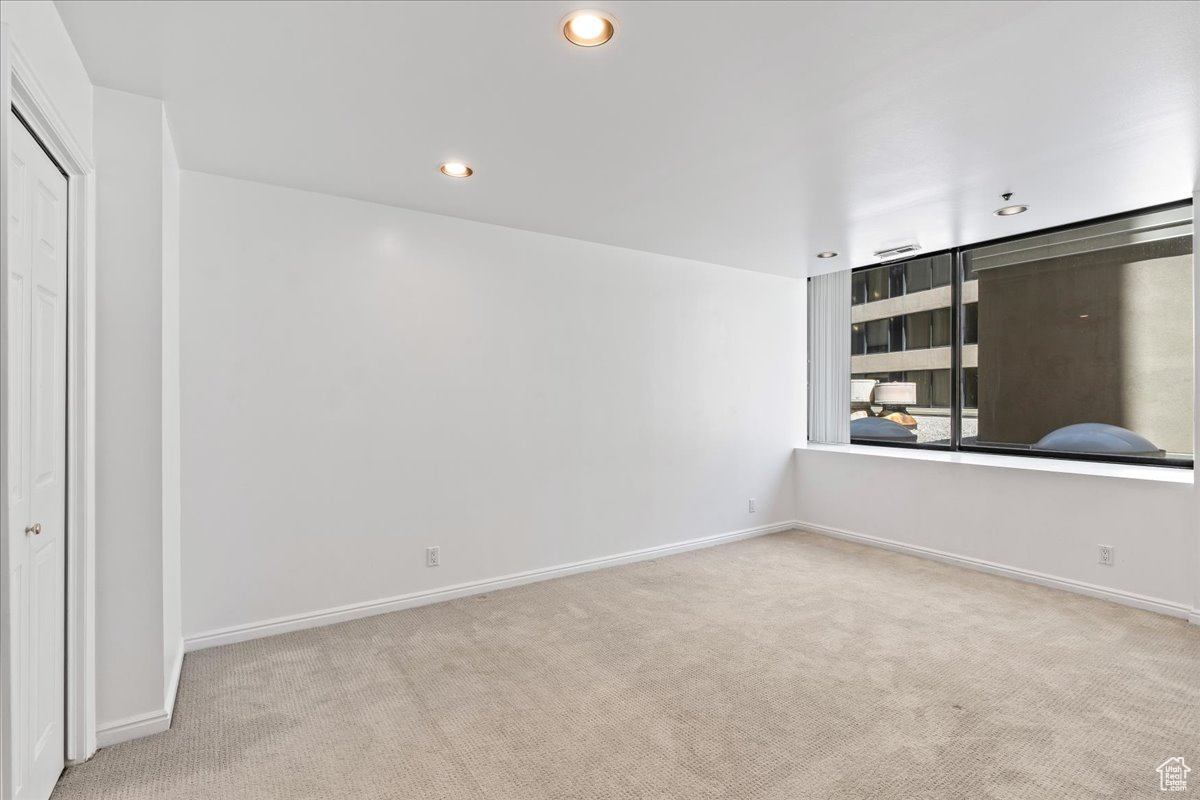 Unfurnished room with light colored carpet