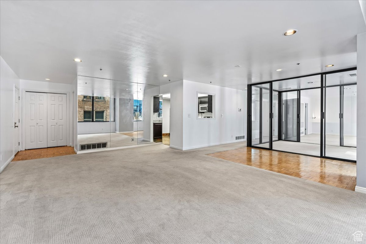 Unfurnished living room with light colored carpet