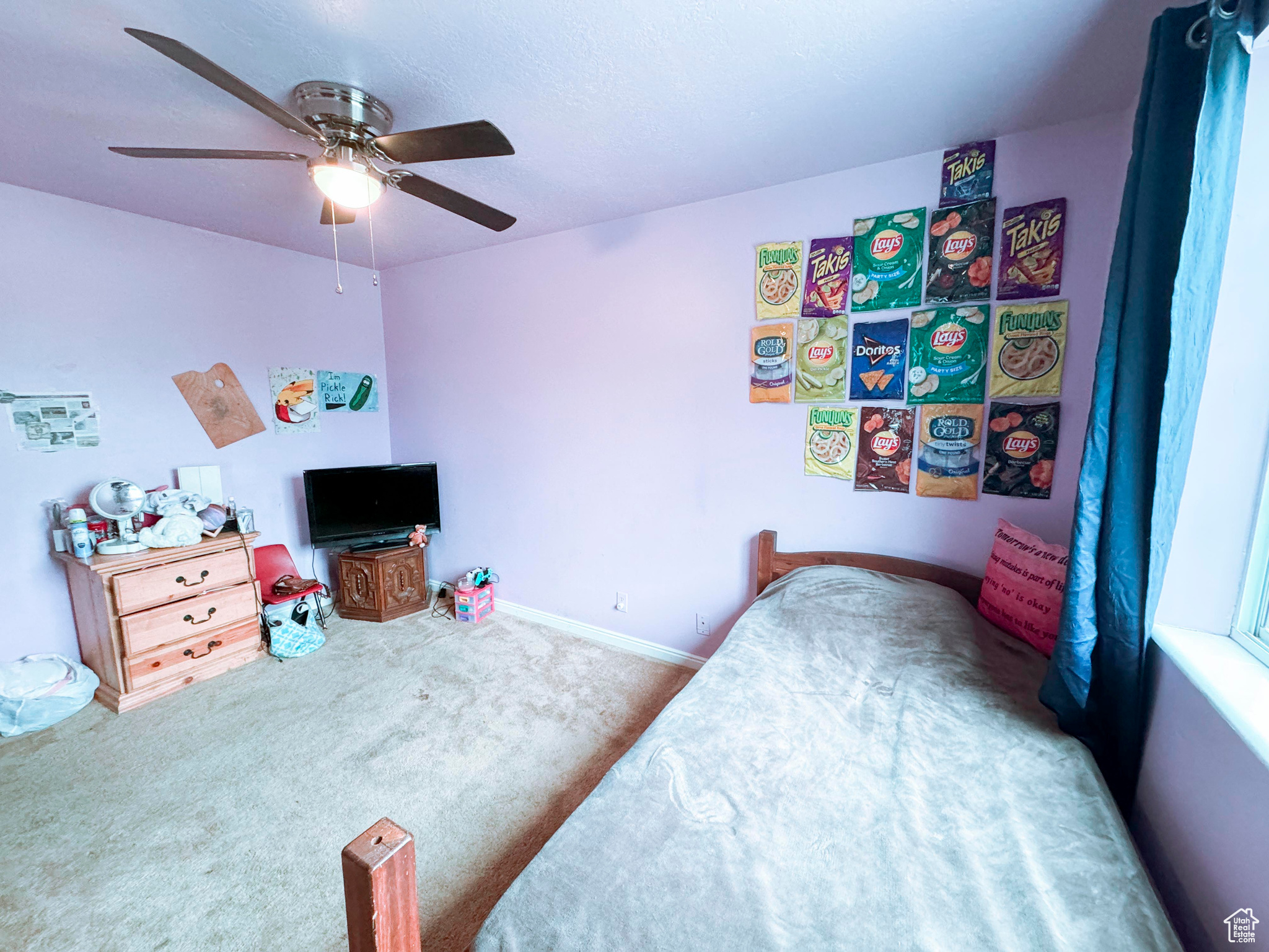 Carpeted bedroom featuring ceiling fan