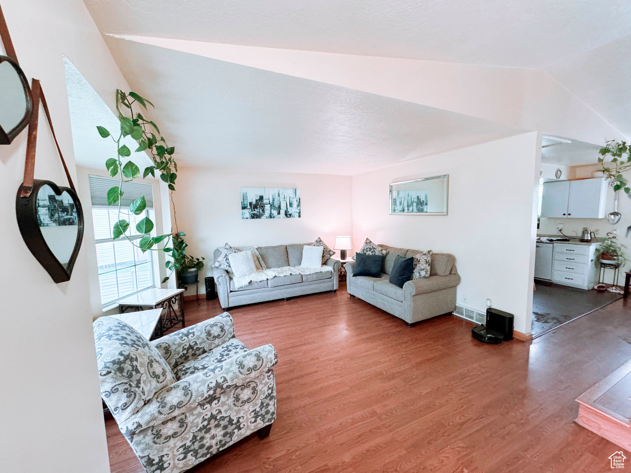 Living room featuring hardwood / wood-style flooring and lofted ceiling