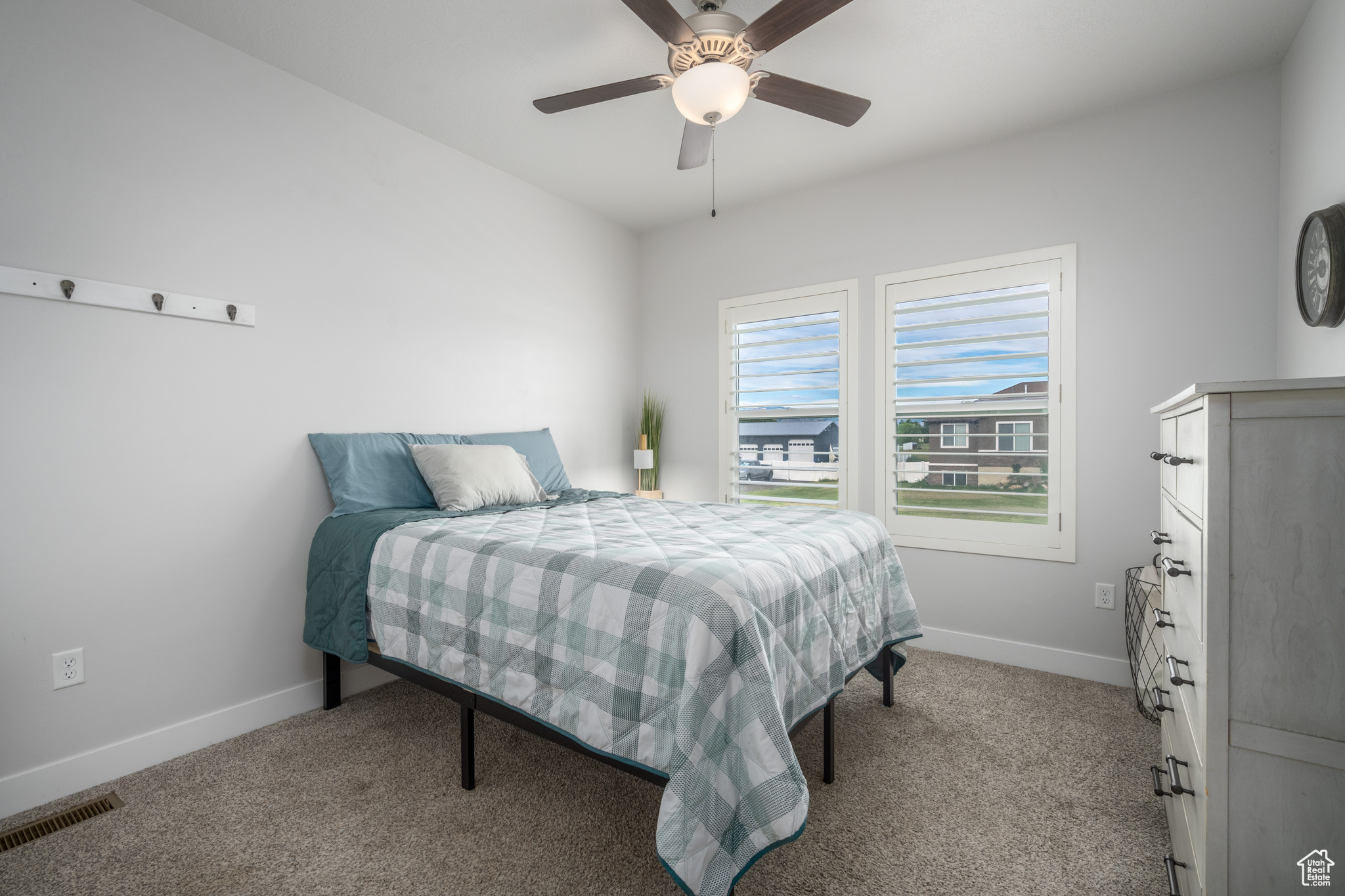 Carpeted bedroom with ceiling fan