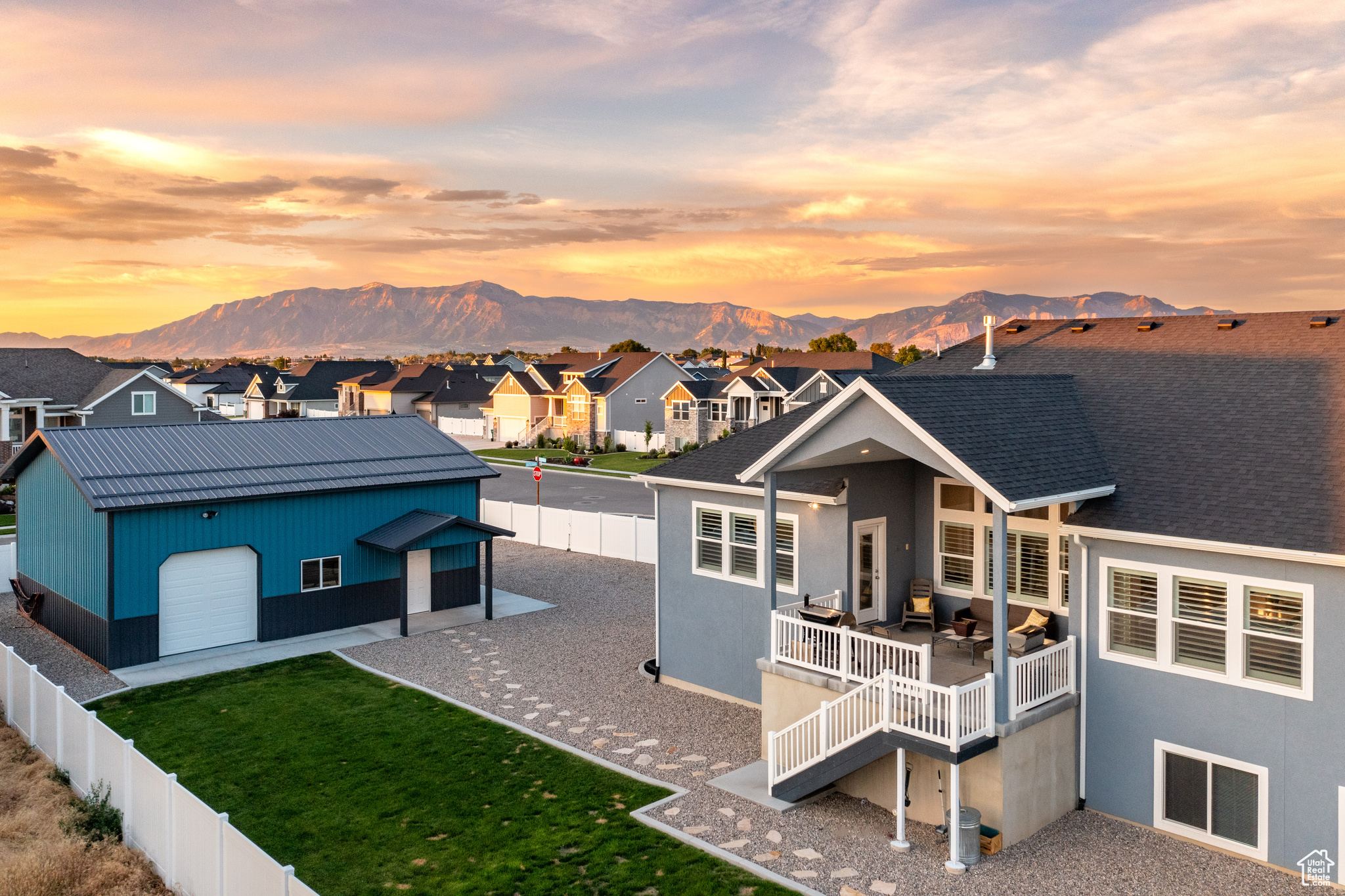 View of front facade with a garage, a mountain view, and a balcony