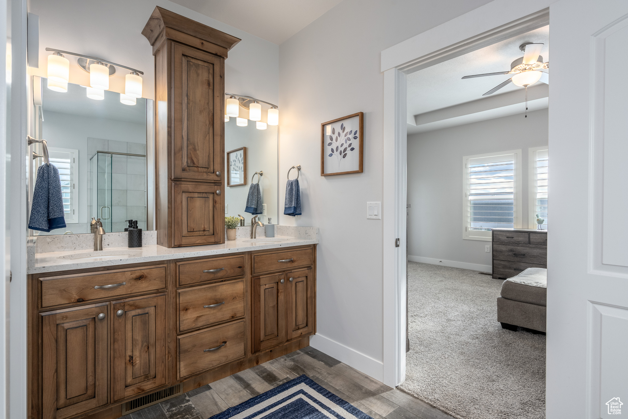 Bathroom featuring dual vanity and ceiling fan