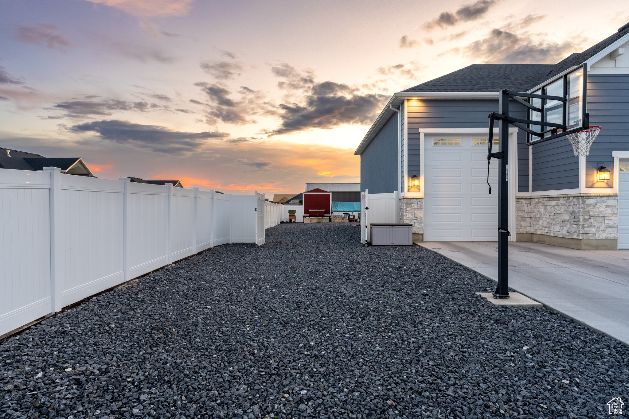 Yard at dusk featuring a garage