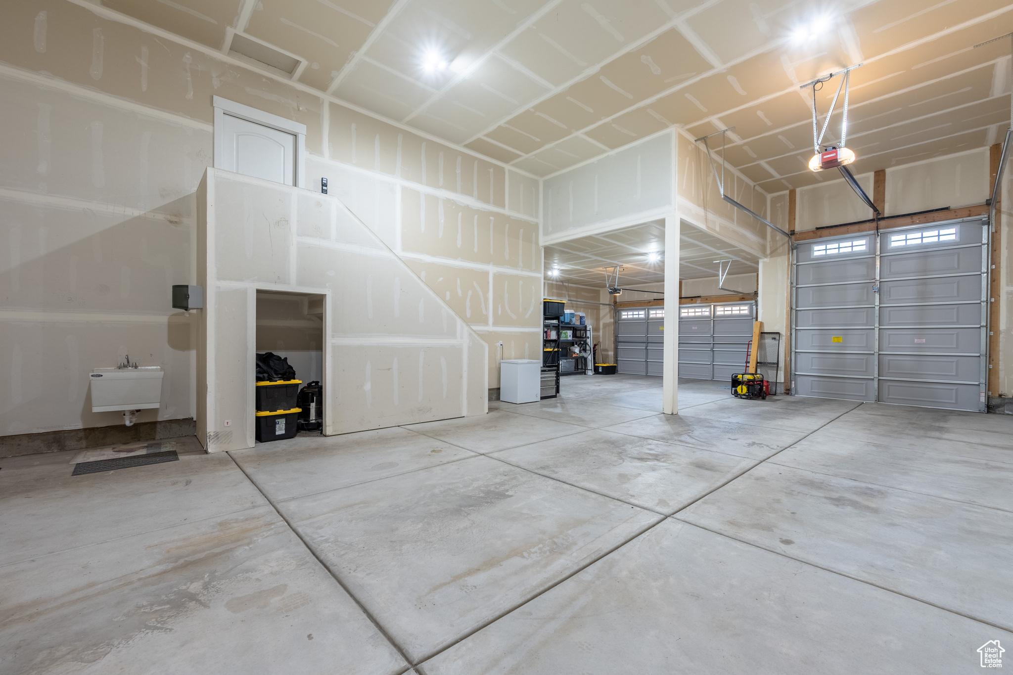 Garage featuring sink and a garage door opener