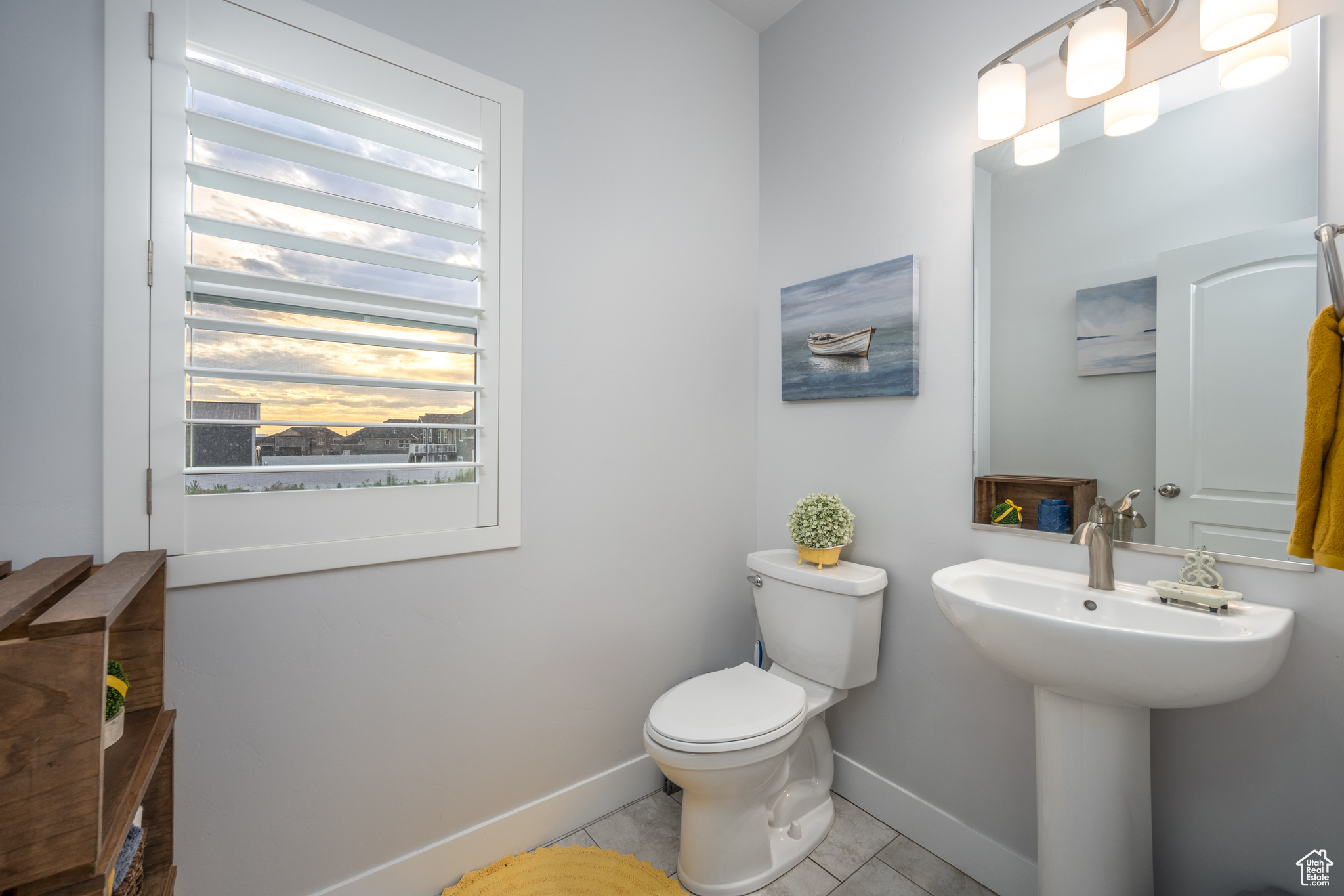 Bathroom with a healthy amount of sunlight, tile flooring, and toilet