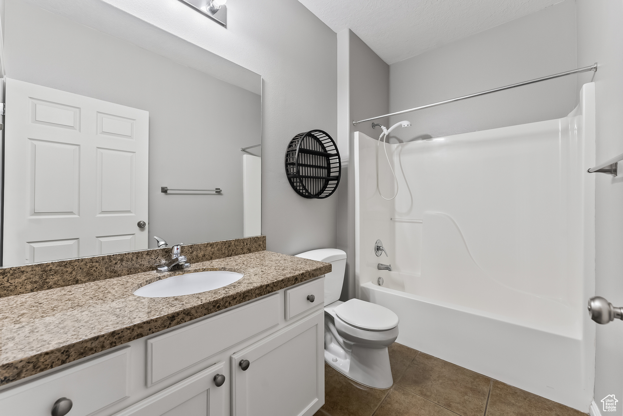 Full bathroom featuring tile flooring, washtub / shower combination, vanity, and toilet