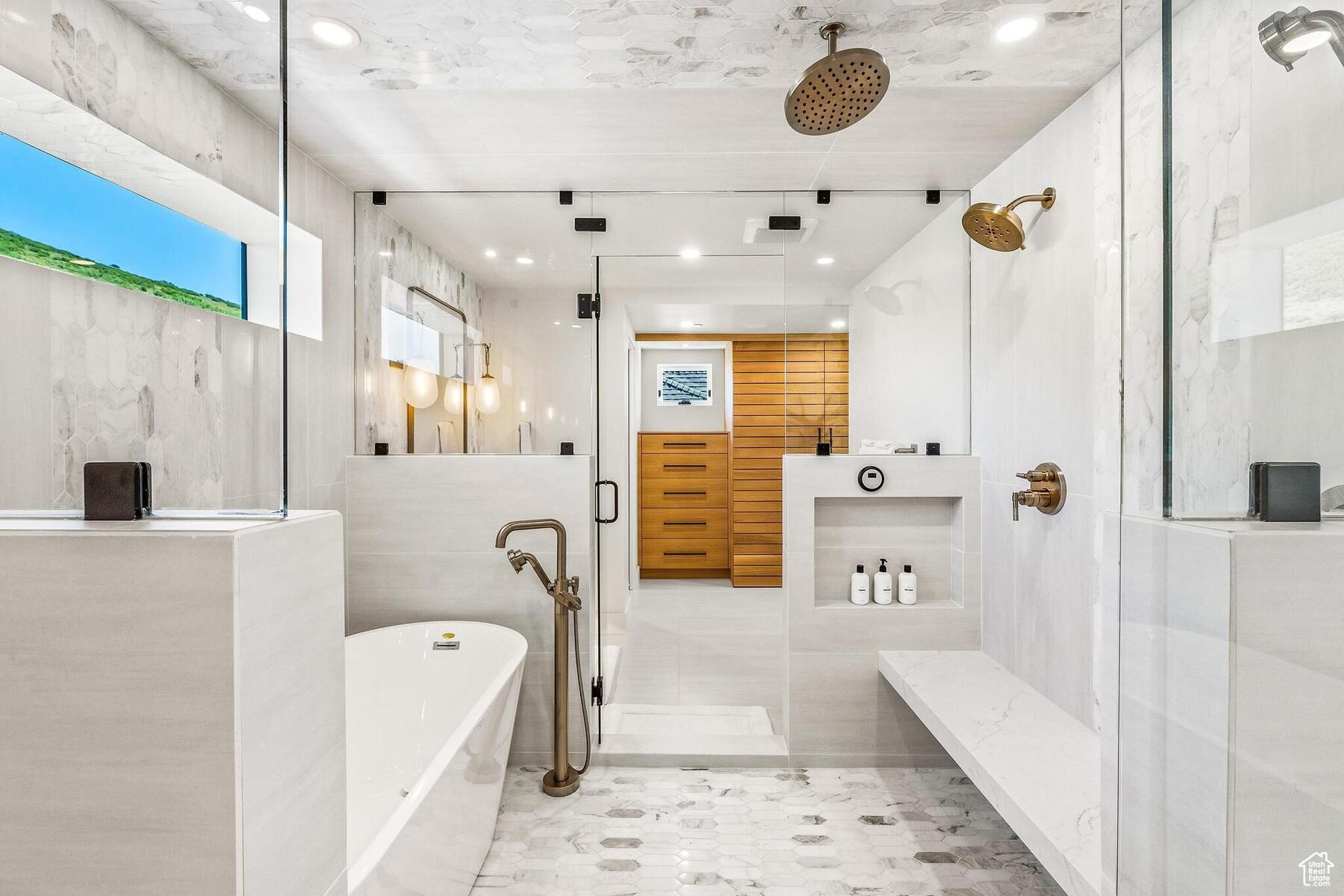 Bathroom with tile floors, tile walls, and plus walk in shower