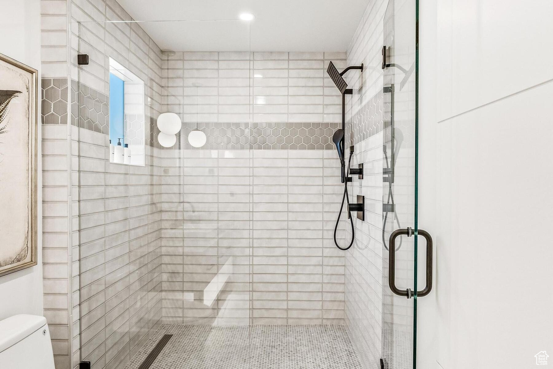 Bathroom featuring an enclosed shower and toilet