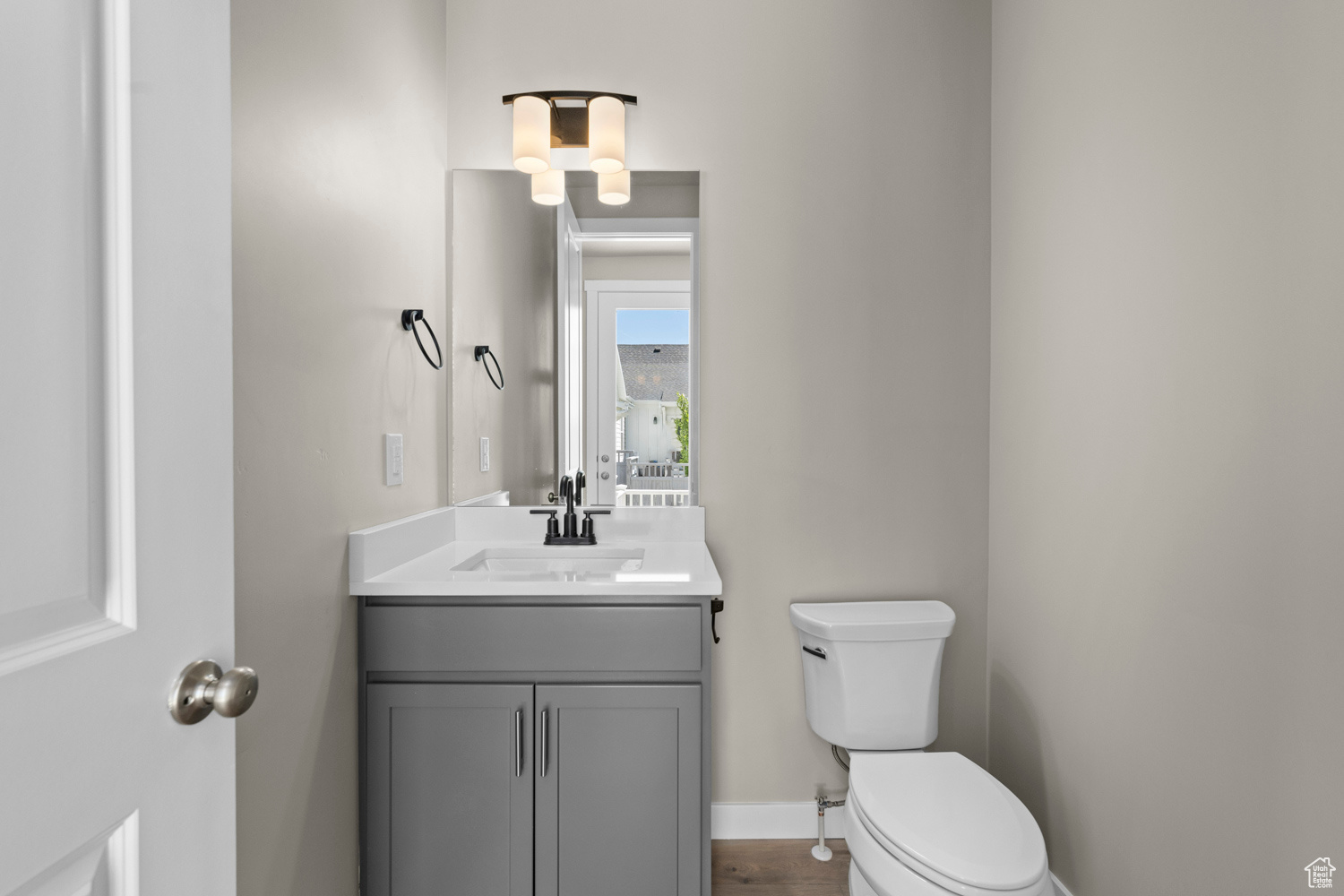 Bathroom featuring large vanity and toilet