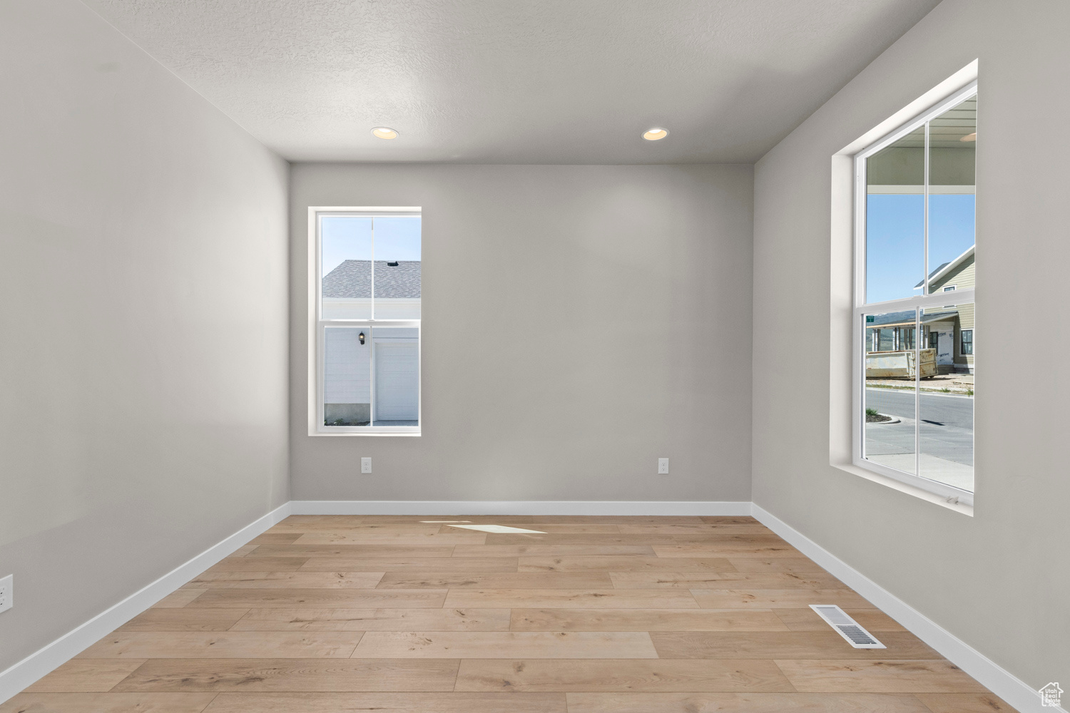 Unfurnished room with plenty of natural light and light wood-type flooring