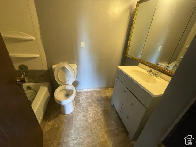 Bathroom featuring tile floors, toilet, and vanity