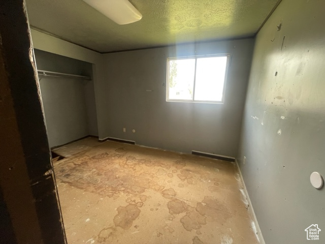 Unfurnished bedroom featuring a textured ceiling