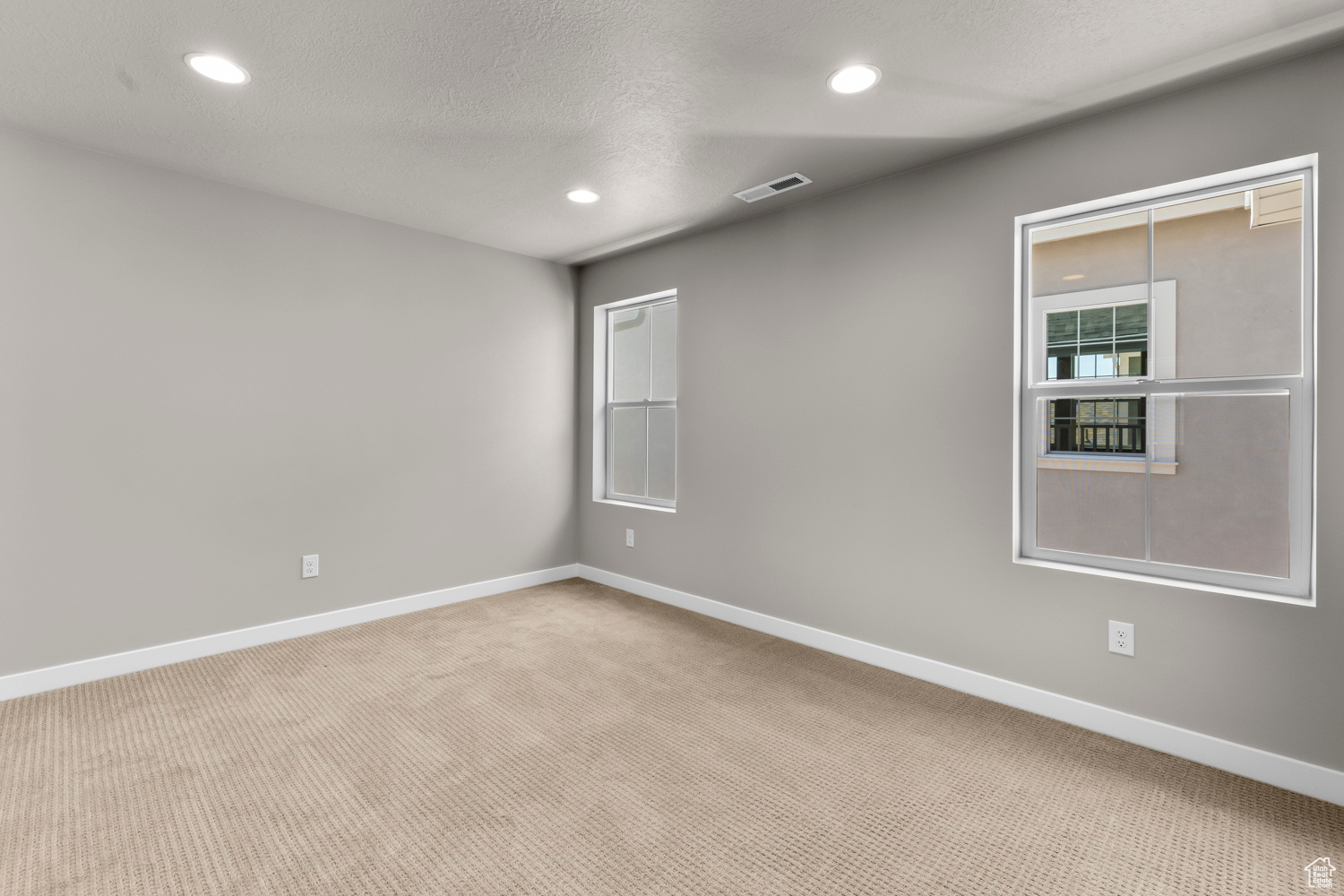 Carpeted spare room with a textured ceiling