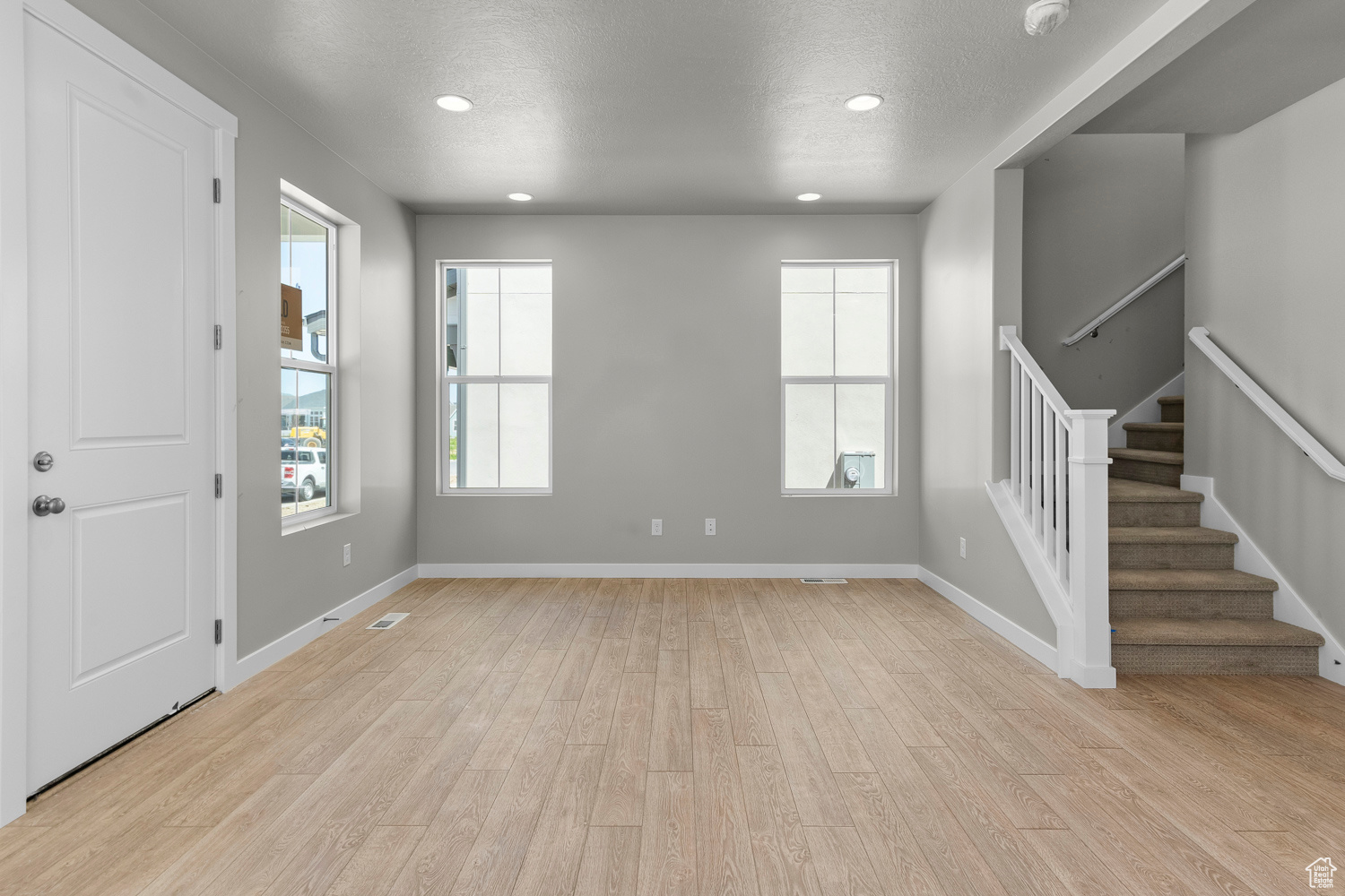 Unfurnished living room with light wood-type flooring