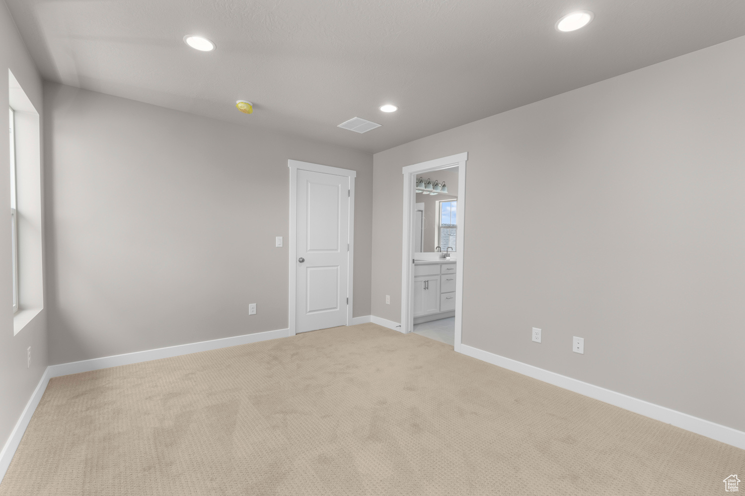 Empty room with sink and light colored carpet