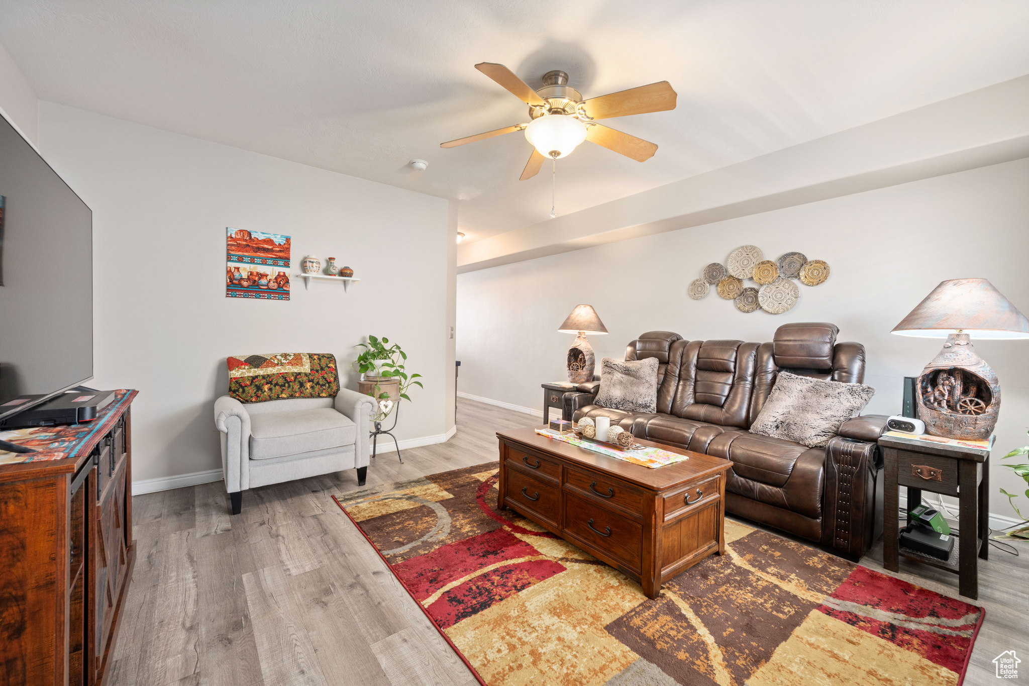 Living room with wood-type flooring and ceiling fan