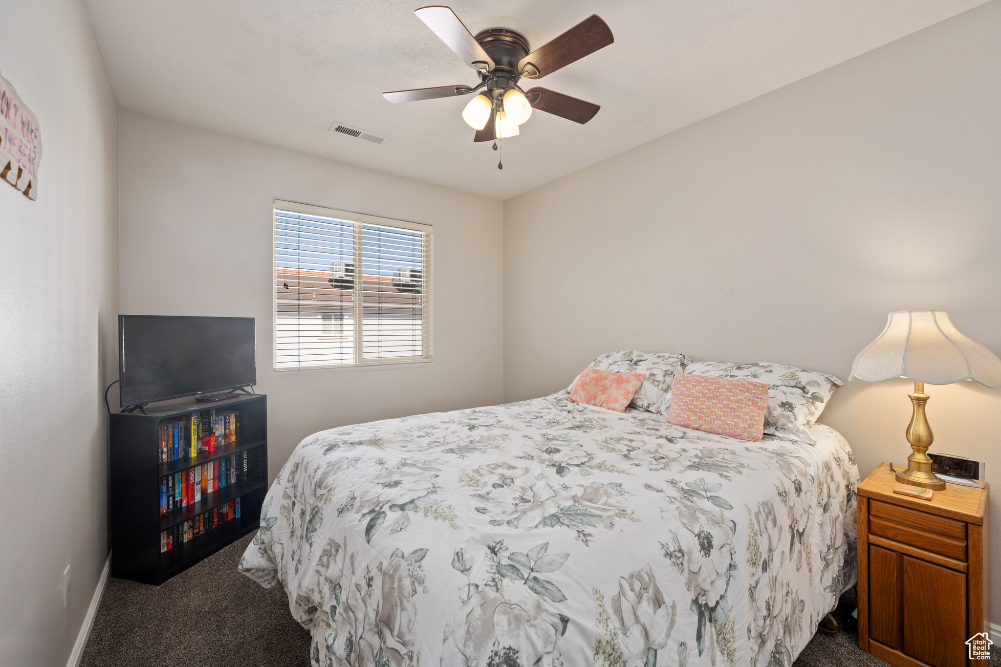 Bedroom featuring dark colored carpet and ceiling fan