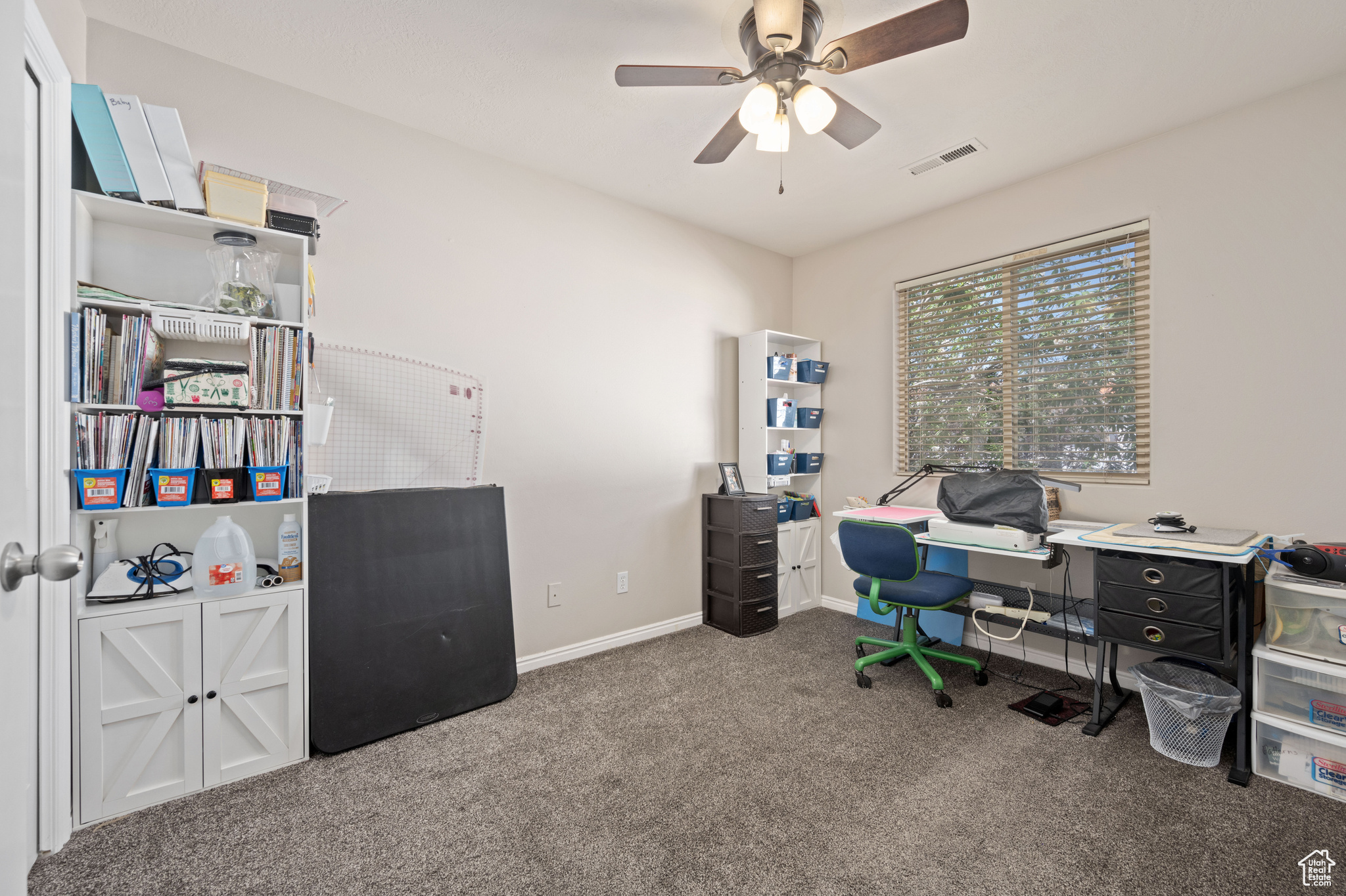 Office with ceiling fan and carpet flooring