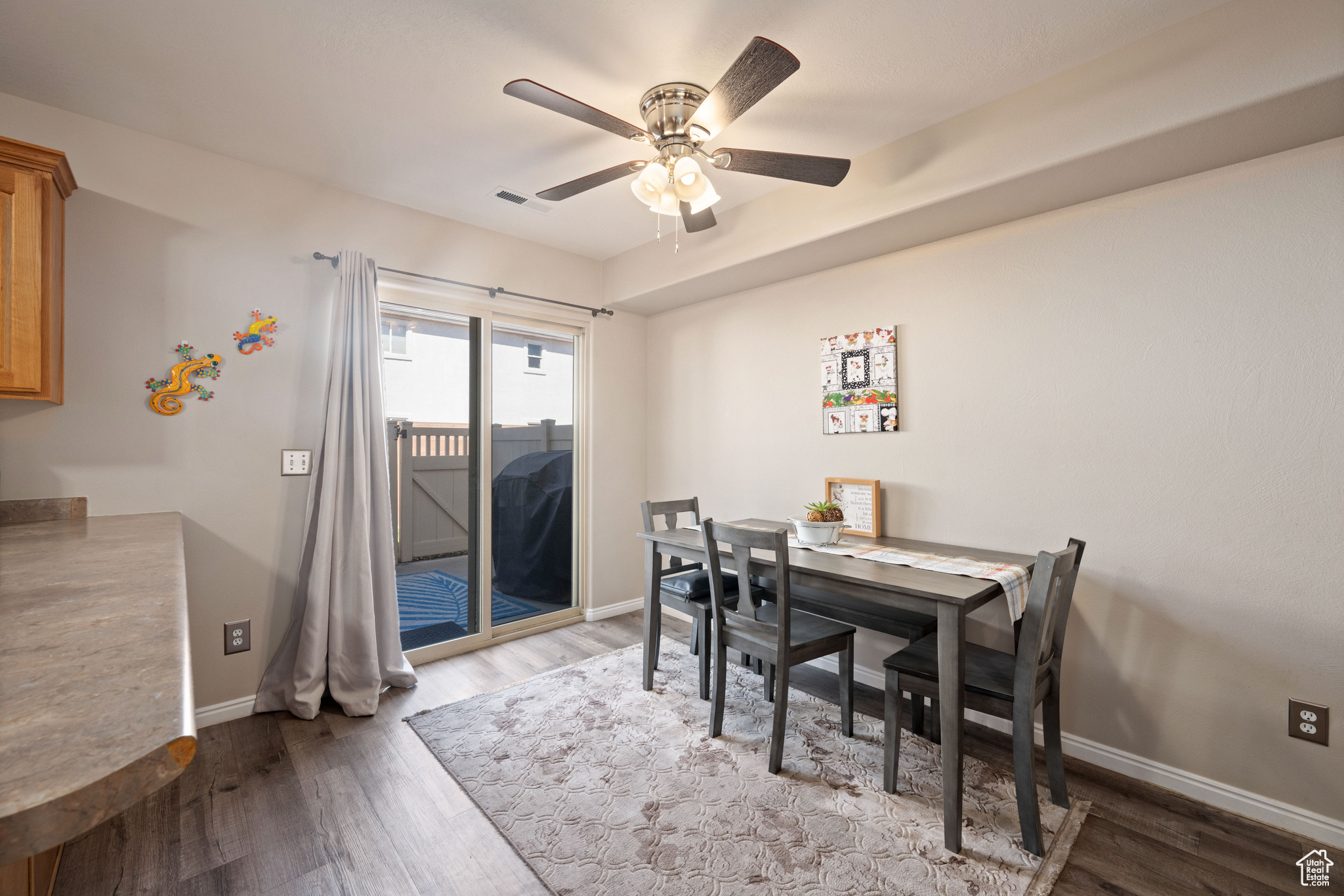 Dining room featuring ceiling fan and light hardwood / wood-style flooring