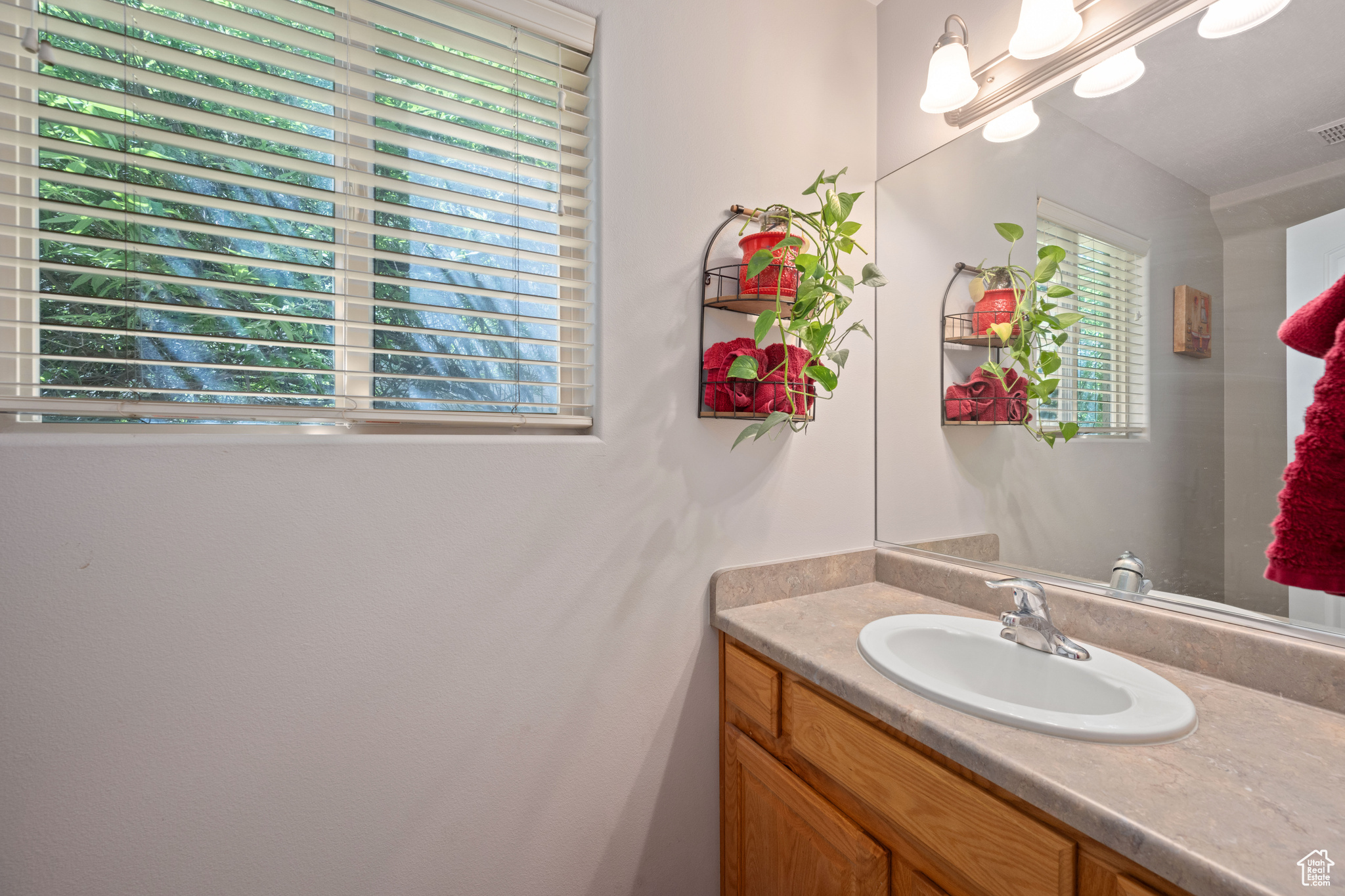 Bathroom featuring vanity with extensive cabinet space