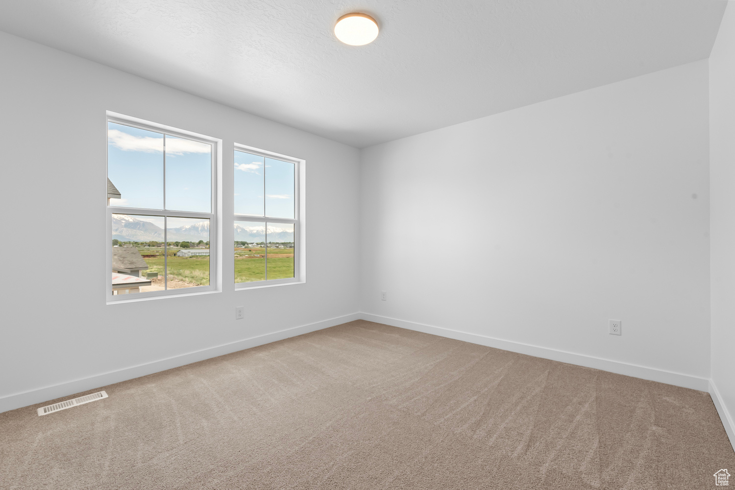 Carpeted spare room with plenty of natural light