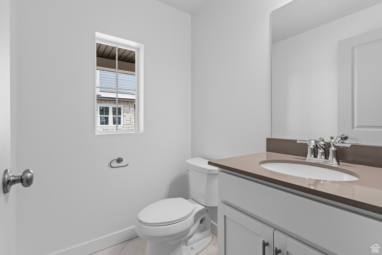 Bathroom with vanity, toilet, and tile floors