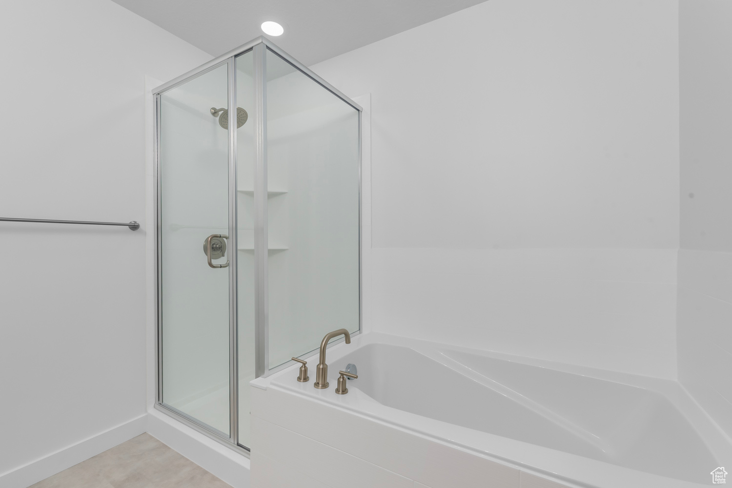 Bathroom featuring tile flooring and separate shower and tub