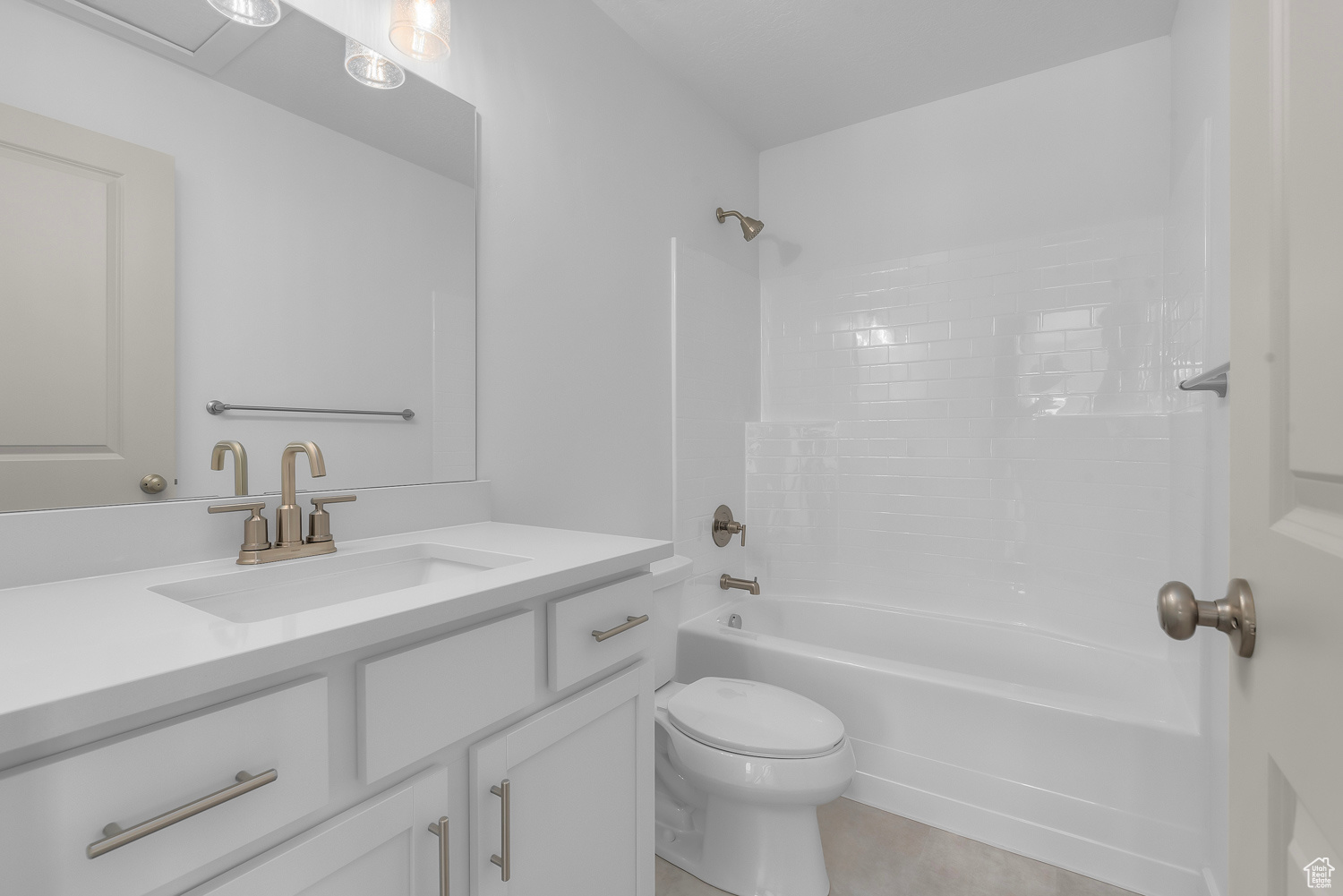 Full bathroom featuring tile flooring, shower / washtub combination, toilet, and vanity