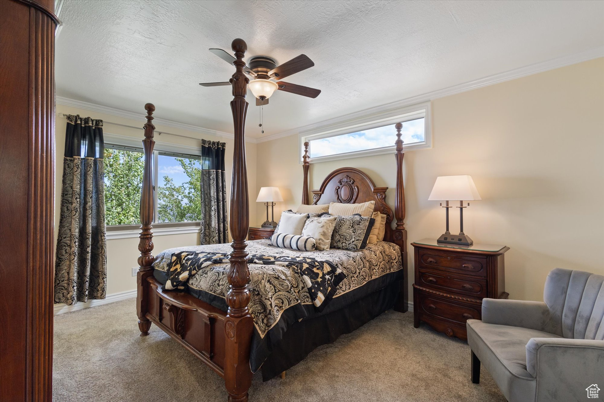 Bedroom with carpet, ornamental molding, ceiling fan, and a textured ceiling