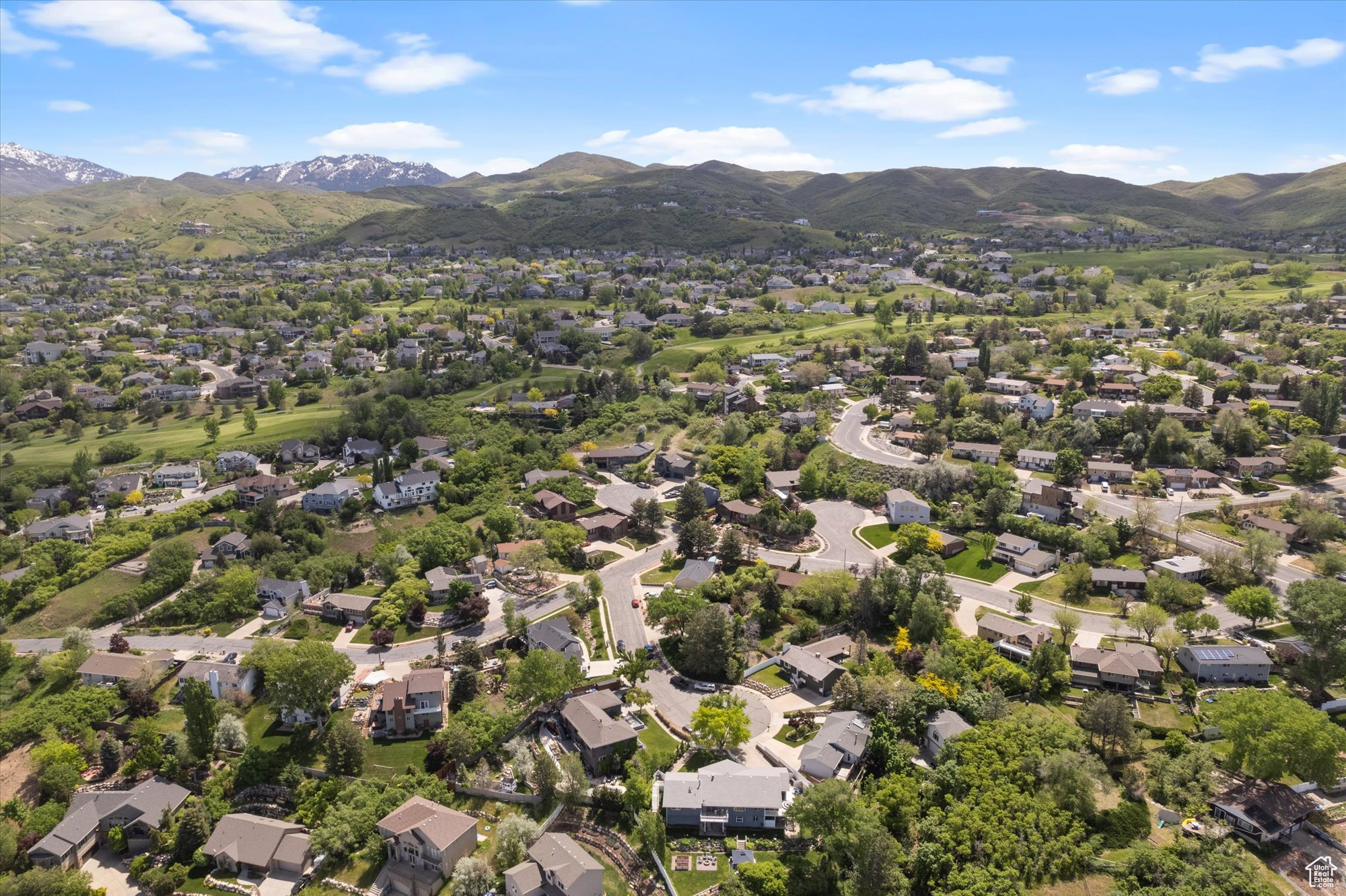 Birds eye view of property with a mountain and golf course view.