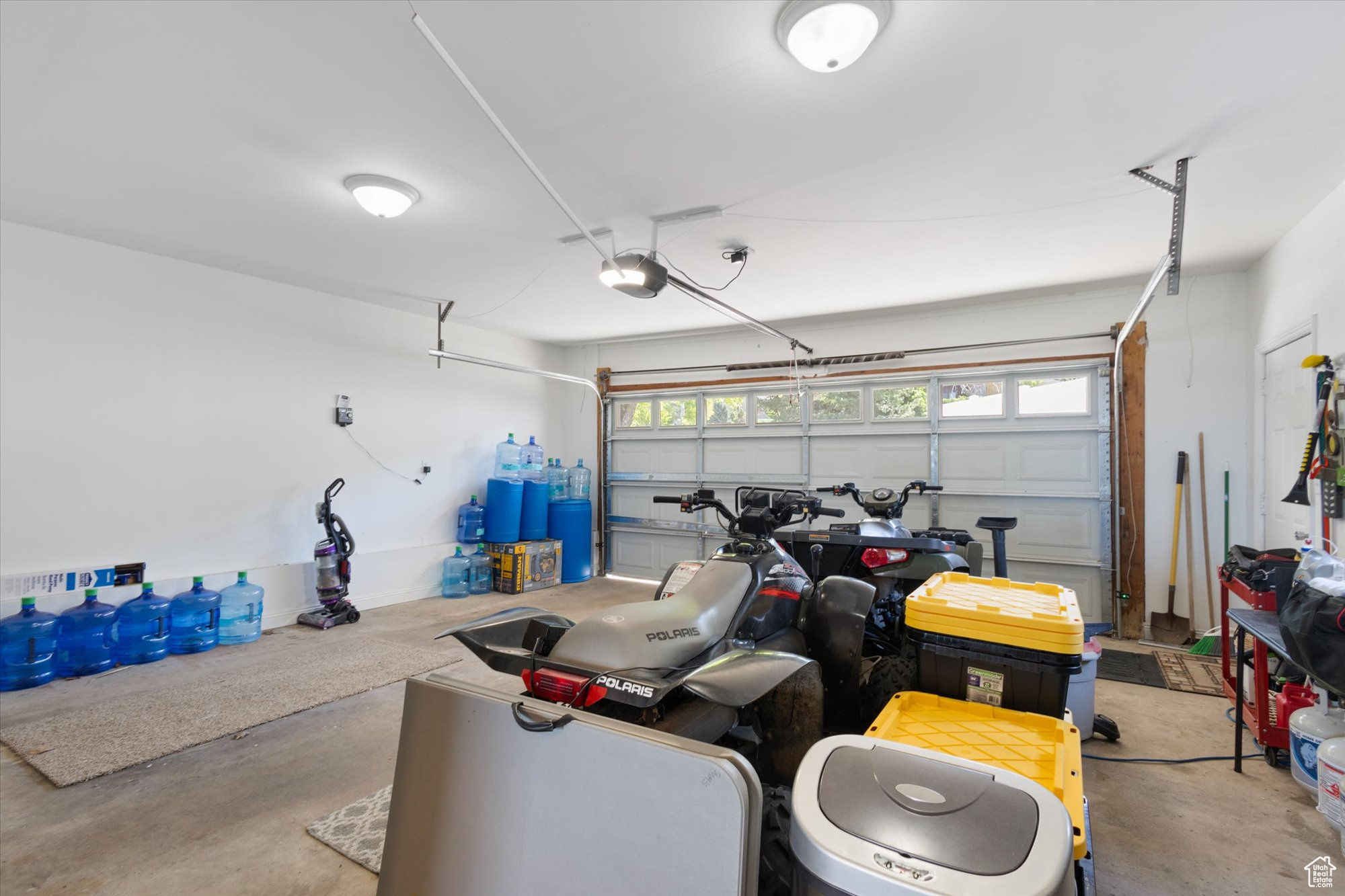 Garage with a garage door opener and 240V outlet