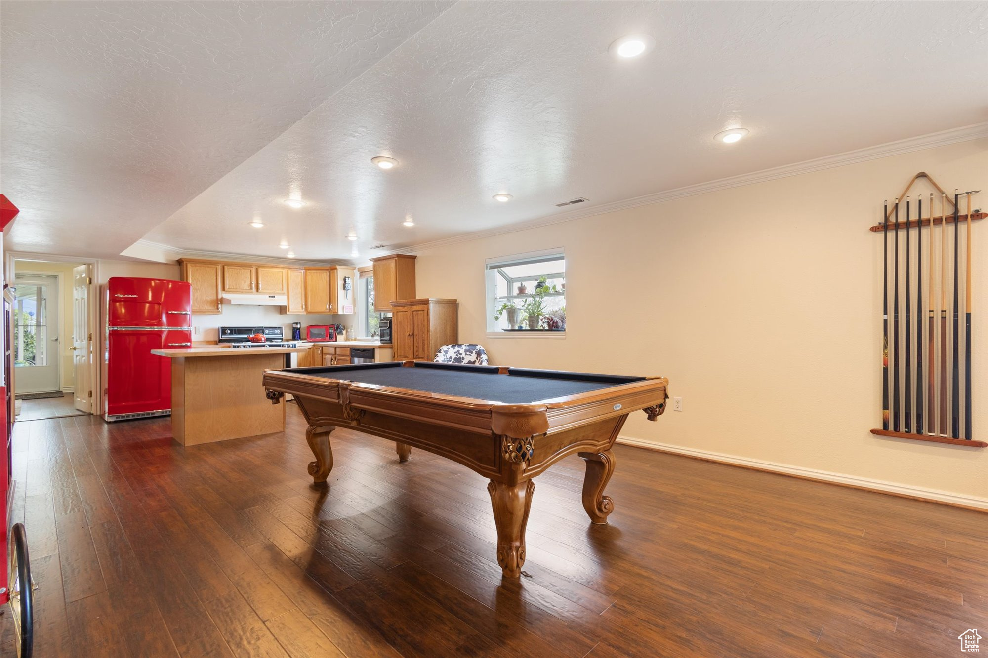 Rec room featuring billiards, dark hardwood / wood-style floors, and crown molding