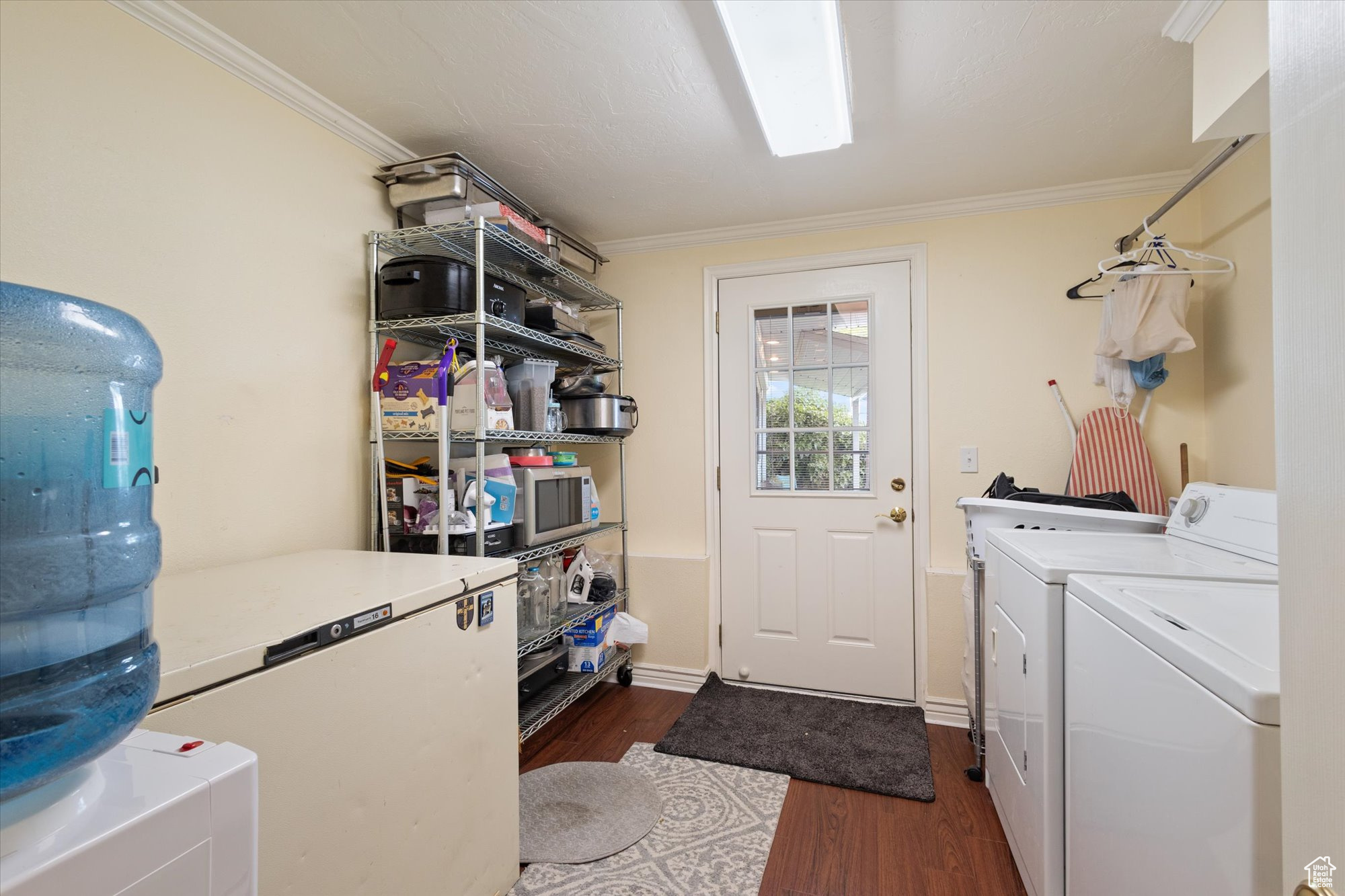 Washroom with sink and washing machine and dryer