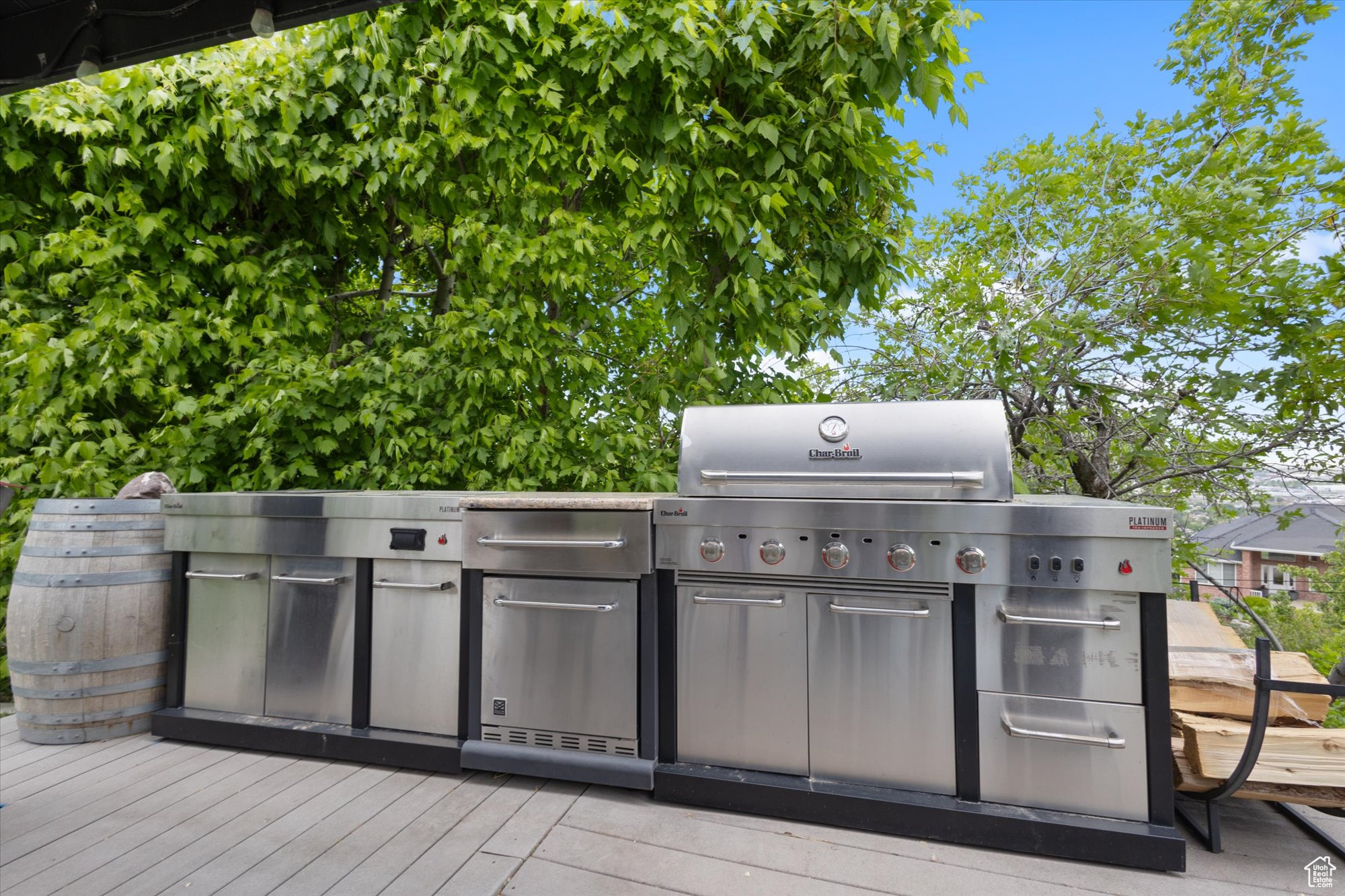 View of gazebo outdoor kitchen, a wooden deck, and area for grilling