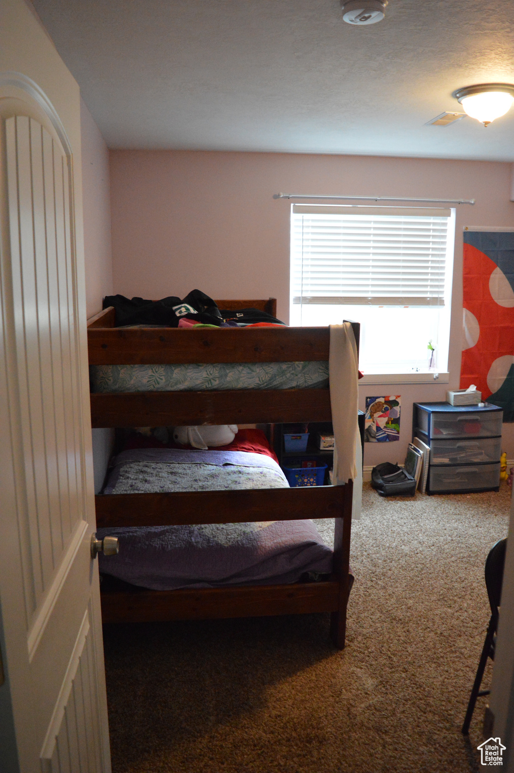 Carpeted bedroom with multiple windows