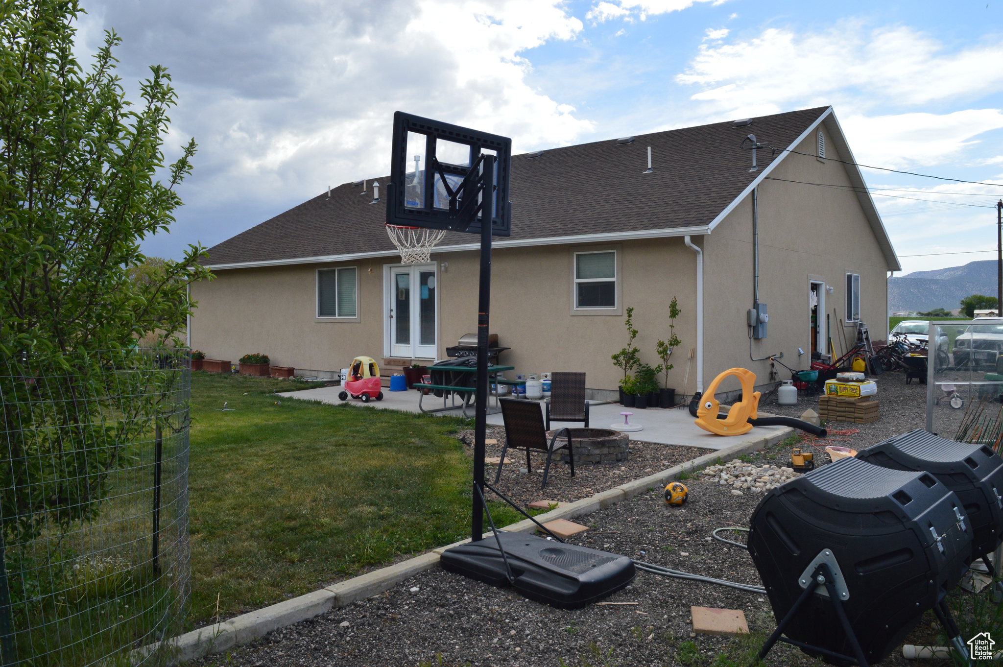 Back of property featuring a patio and a yard