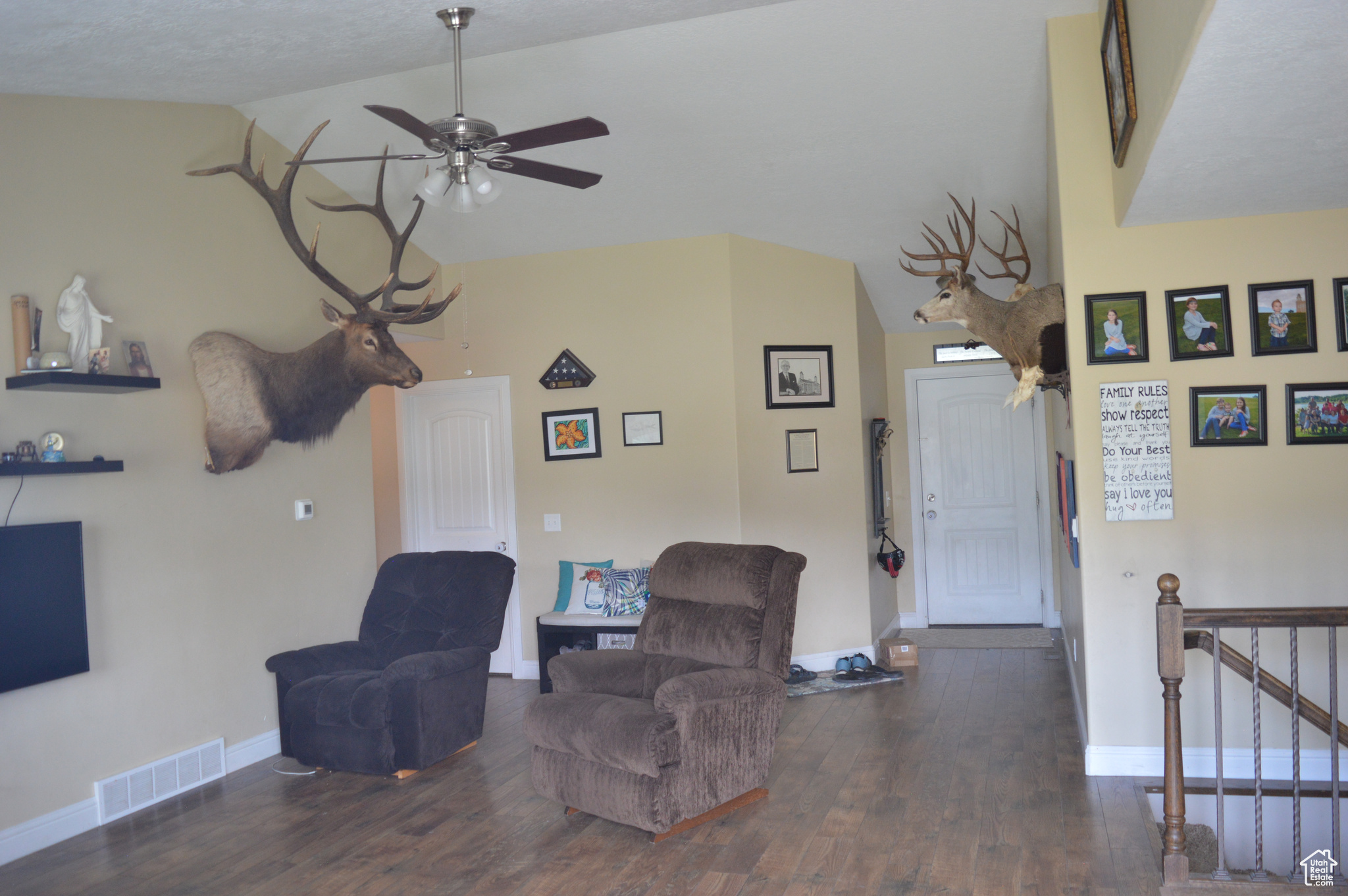 Sitting room featuring ceiling fan, dark hardwood / wood-style flooring, and lofted ceiling