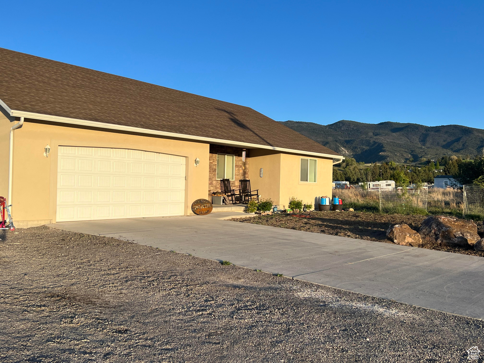 Ranch-style house with a garage and a mountain view