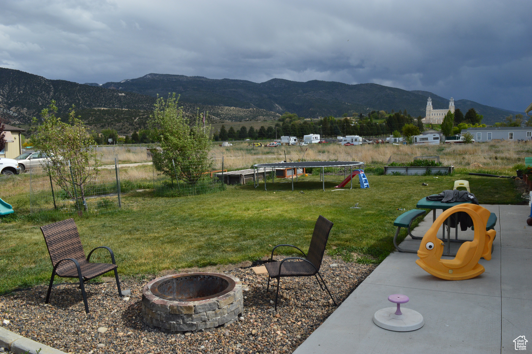 View of yard with a fire pit and a mountain view