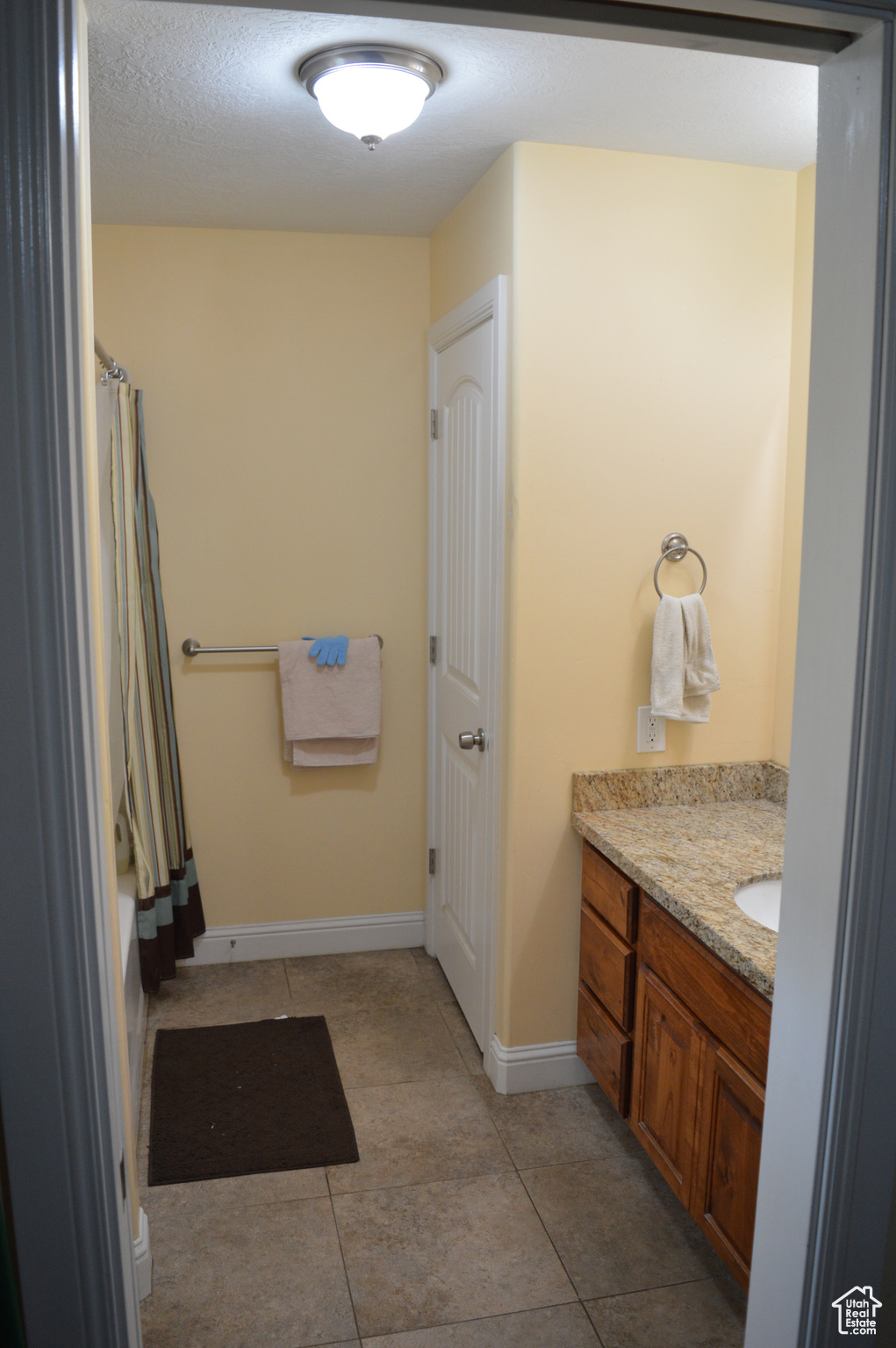 Bathroom with tile flooring and vanity