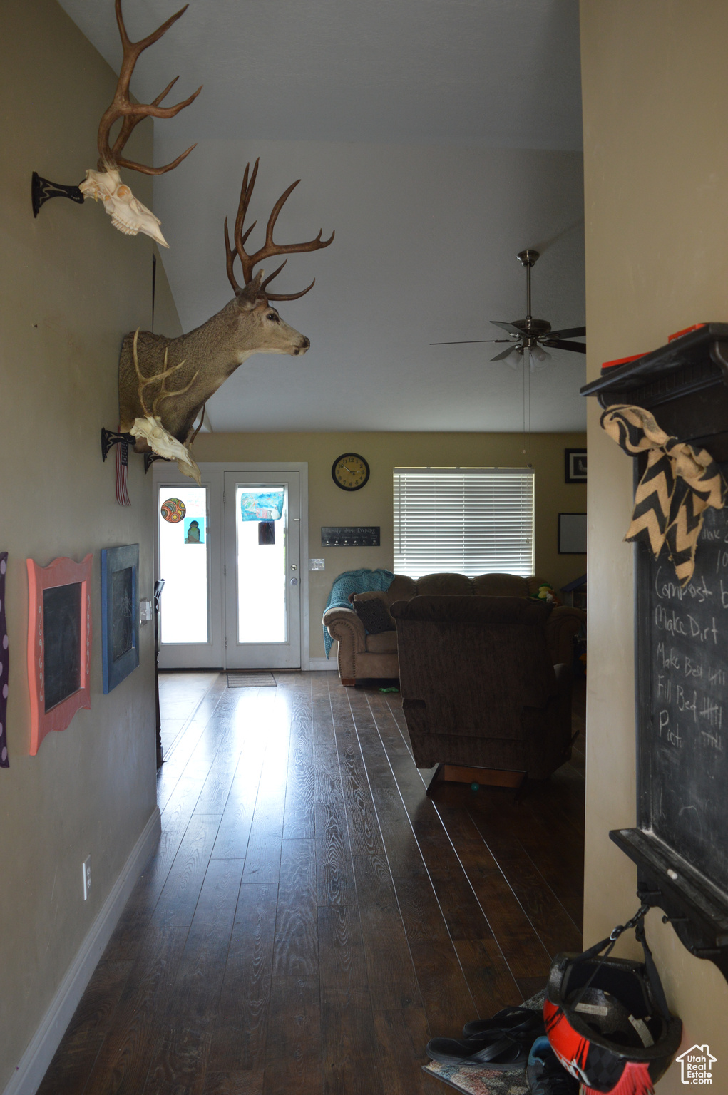 Unfurnished living room featuring ceiling fan, french doors, hardwood / wood-style flooring, and vaulted ceiling