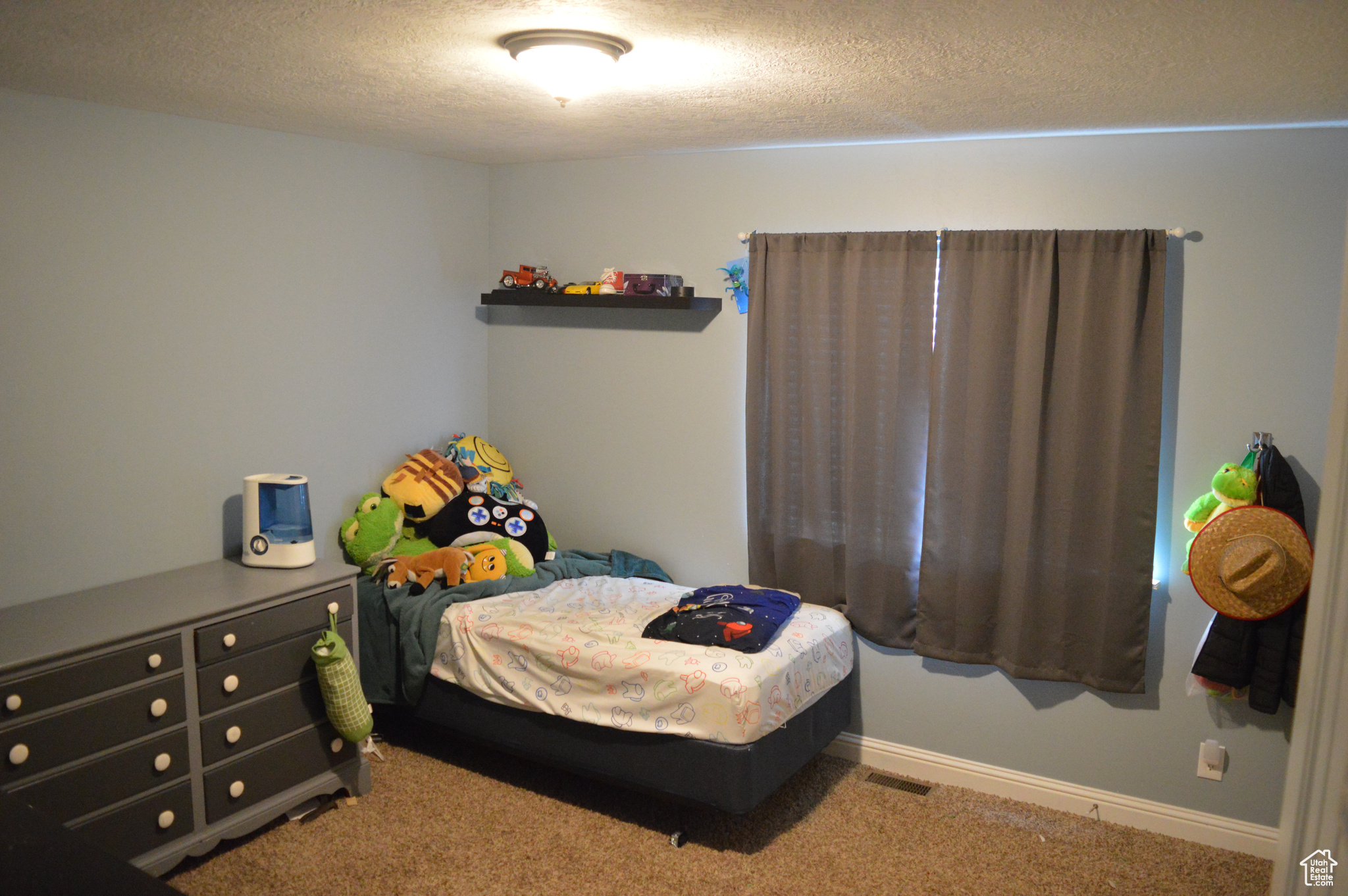 Carpeted bedroom with a textured ceiling