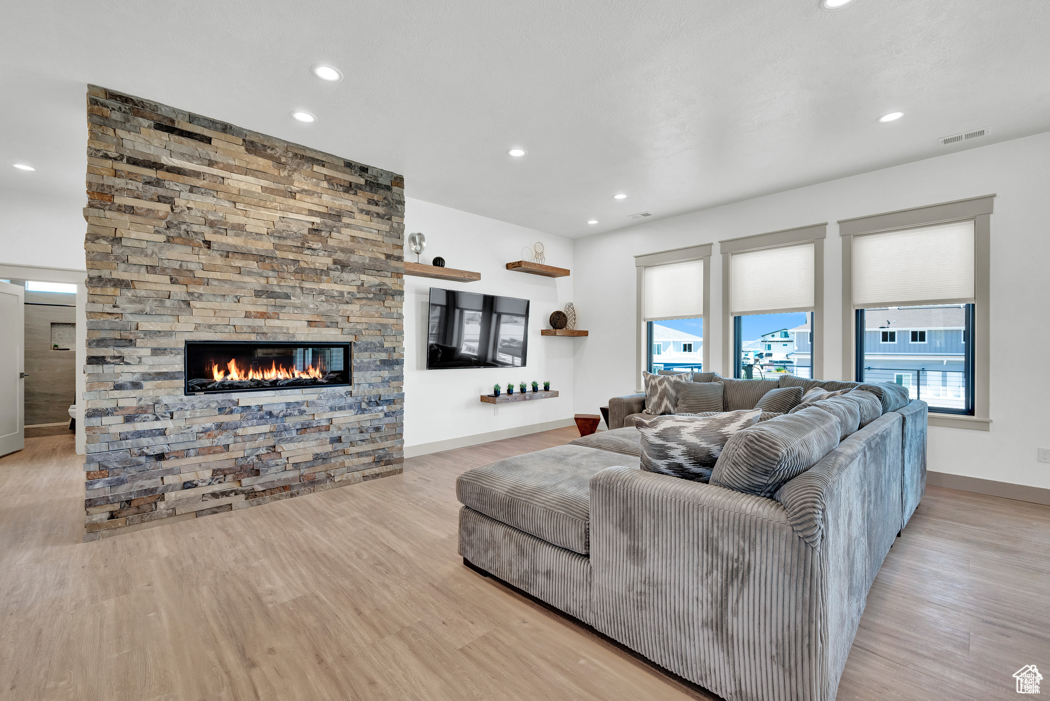 Living room featuring light hardwood / wood-style floors and a fireplace