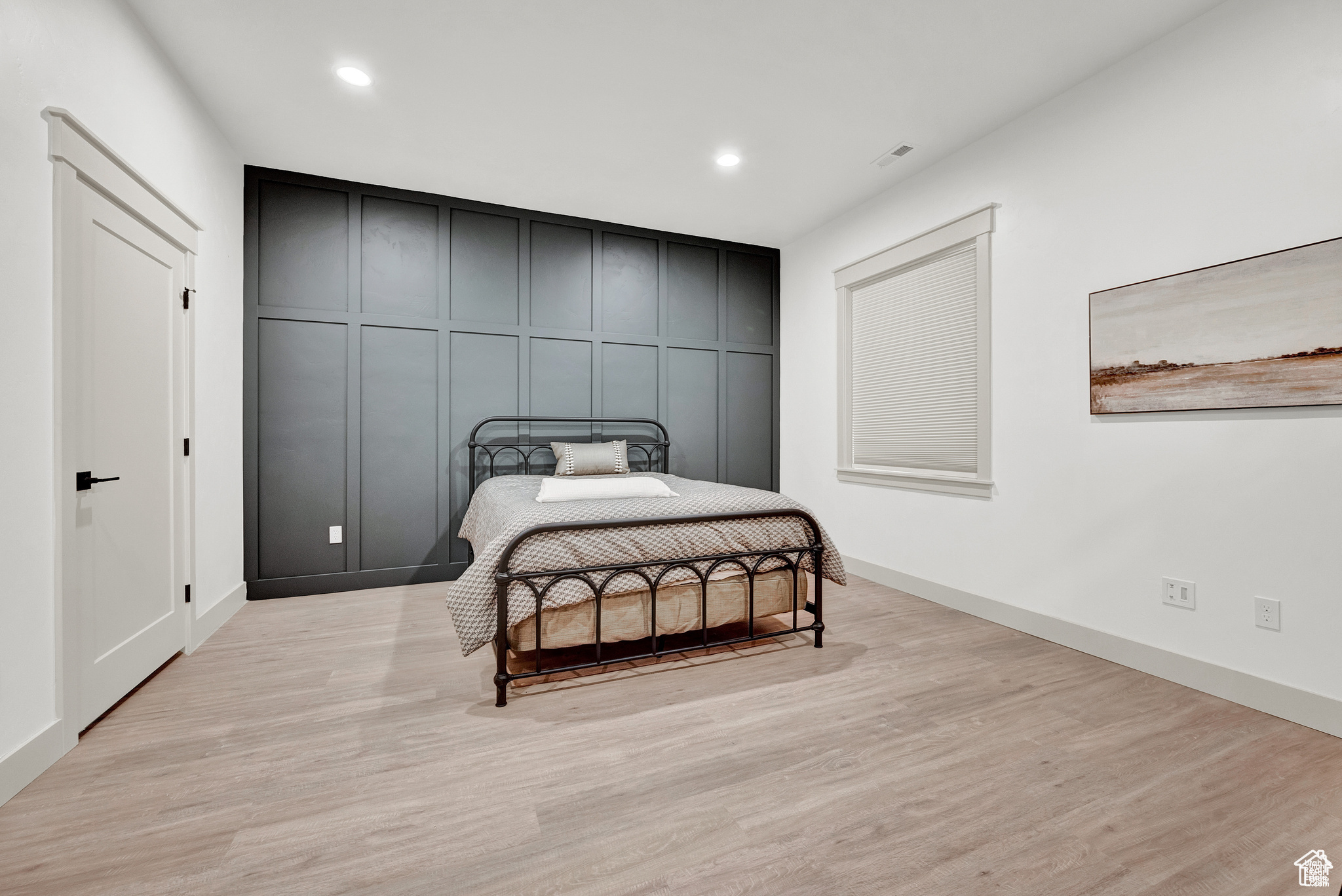 Bedroom with light hardwood / wood-style flooring