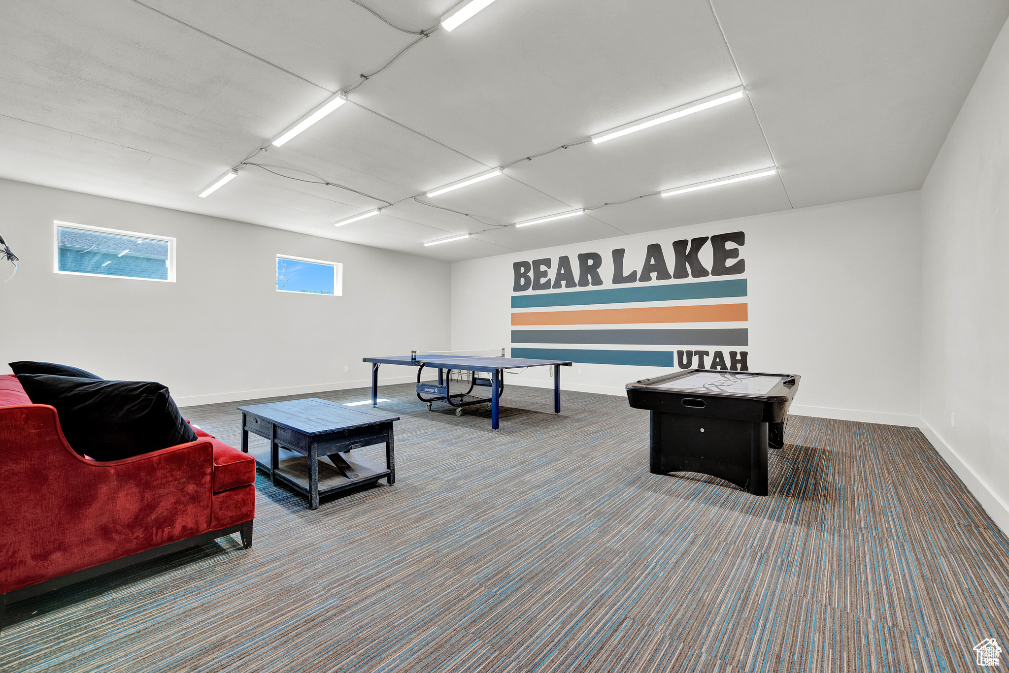 Game room featuring dark colored carpet