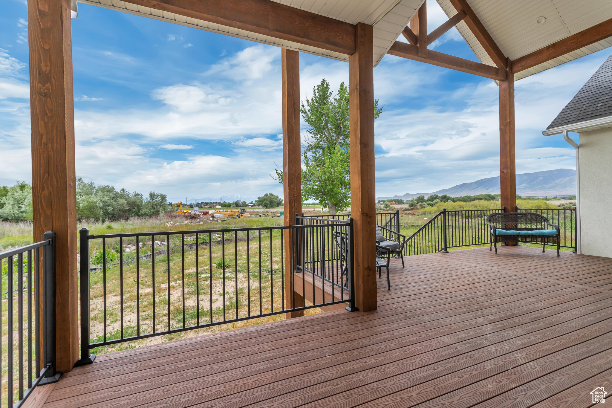 Large Trex deck featuring a mountain view with entries from the kitchen and primary bedroom